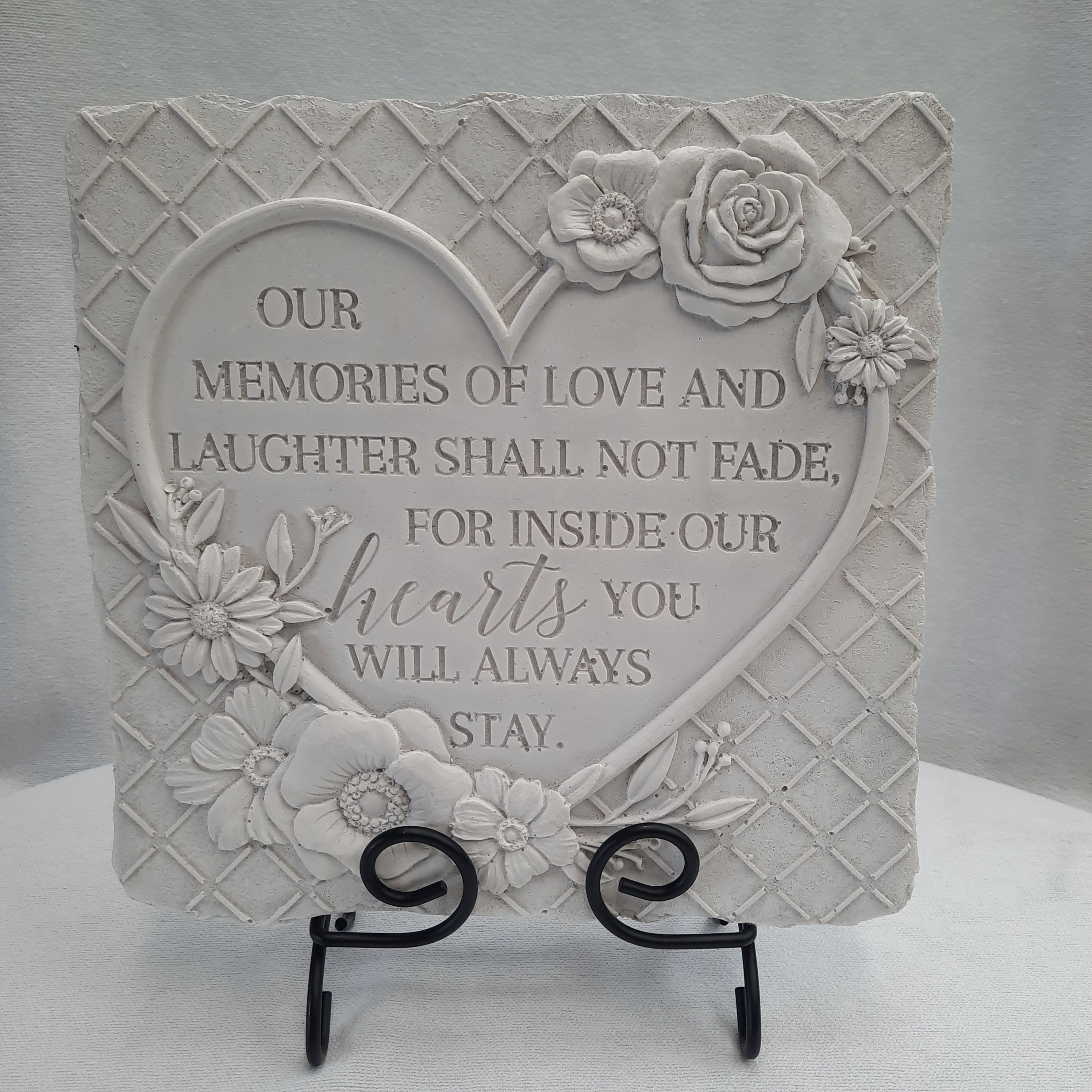 Decorative memorial plaque with raised flowers and a heart-shaped quote