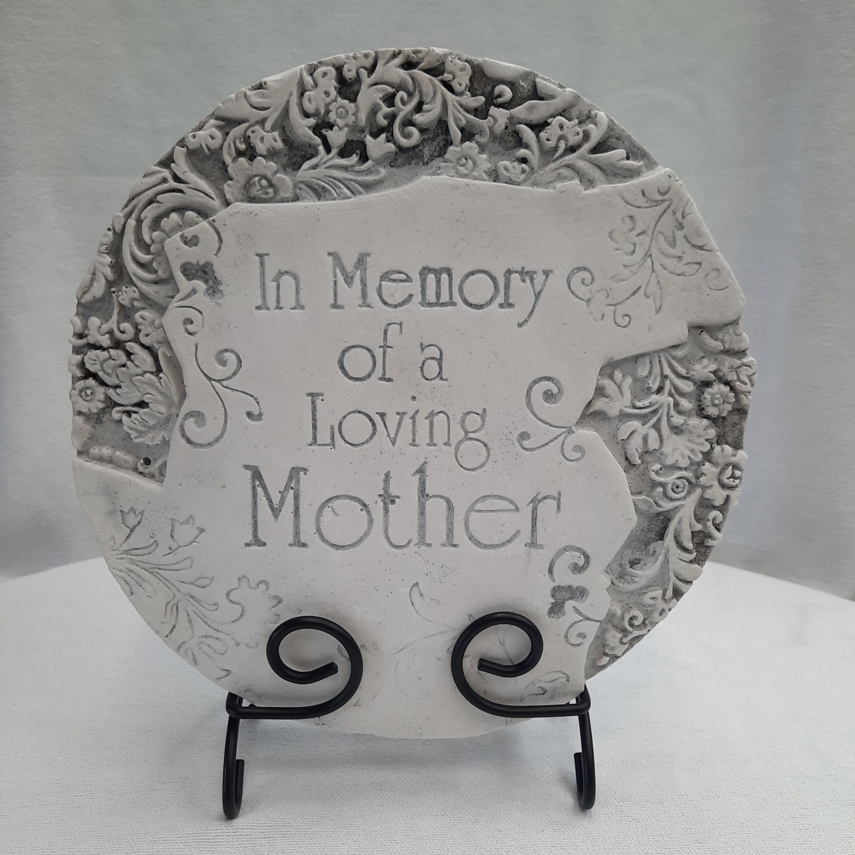 Decorative memorial plaque reading "In Memory of a Loving Mother" on a stand