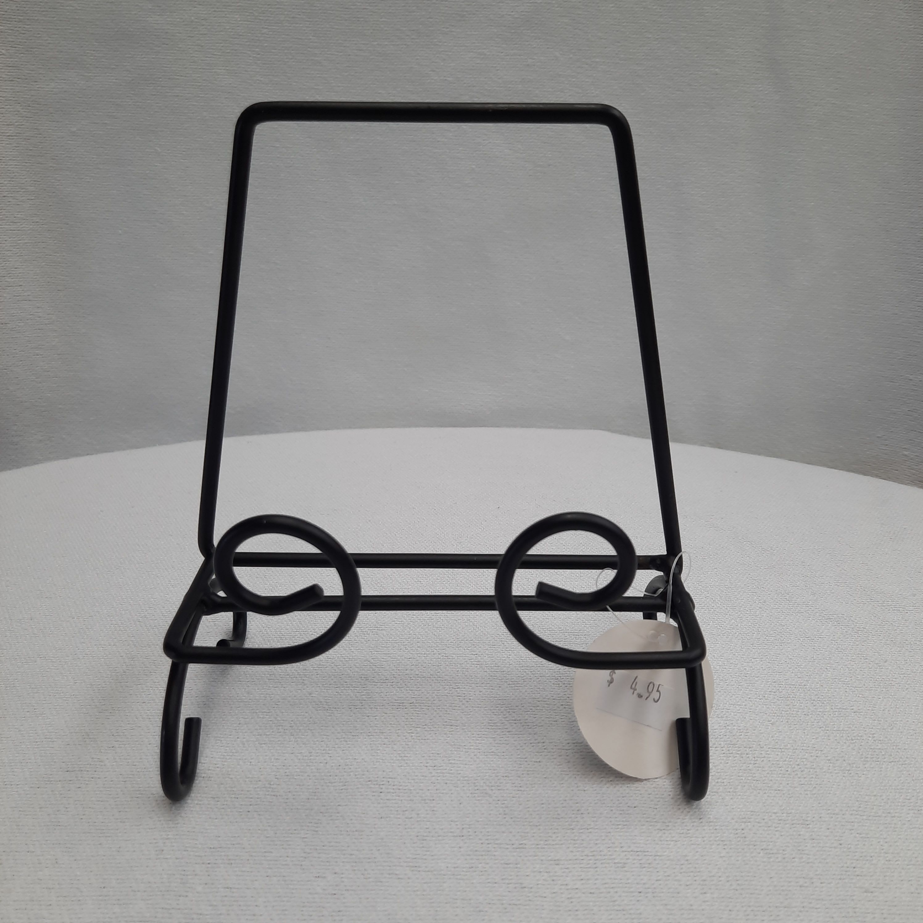 Black metal display stand with a price tag