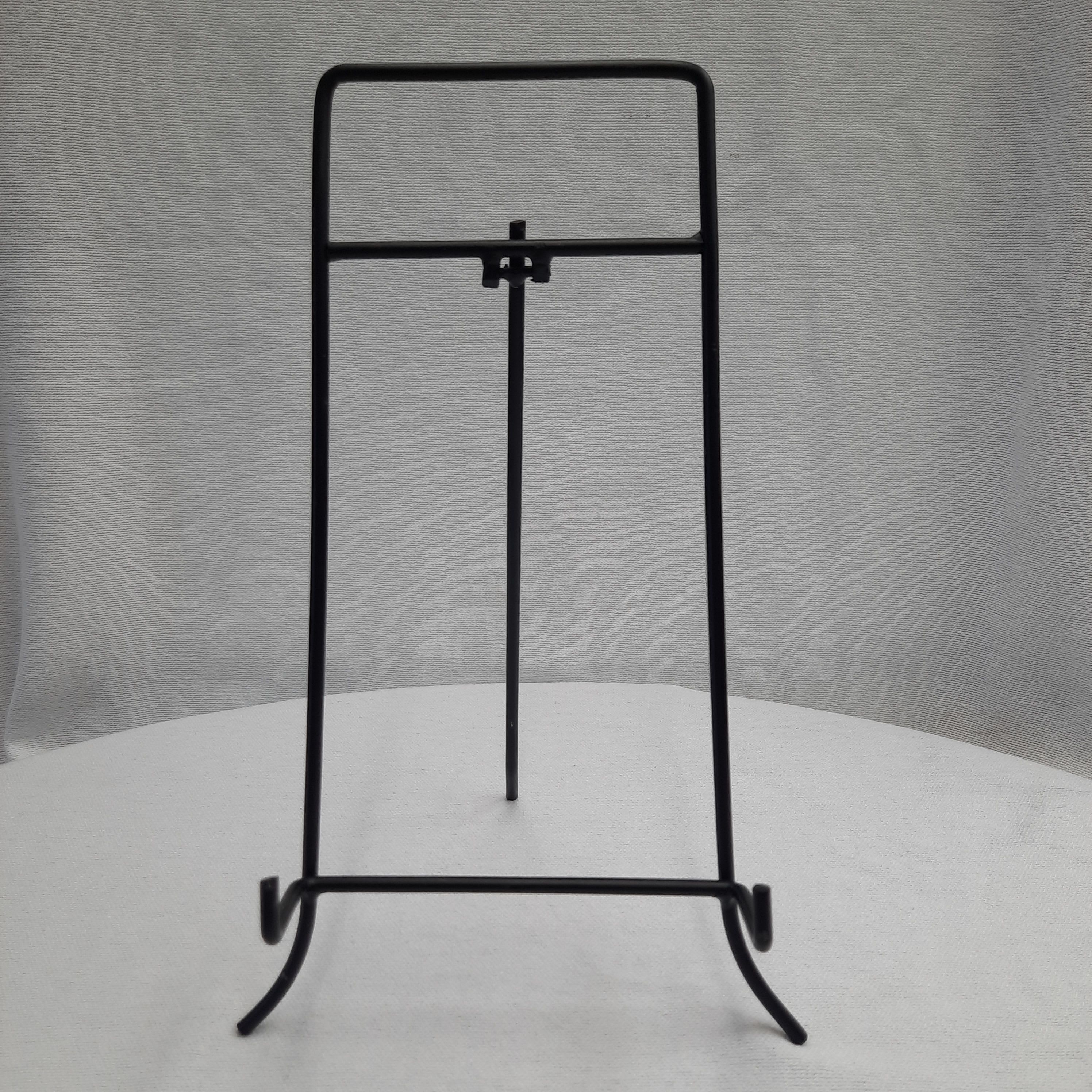 Black metal display stand on a white surface