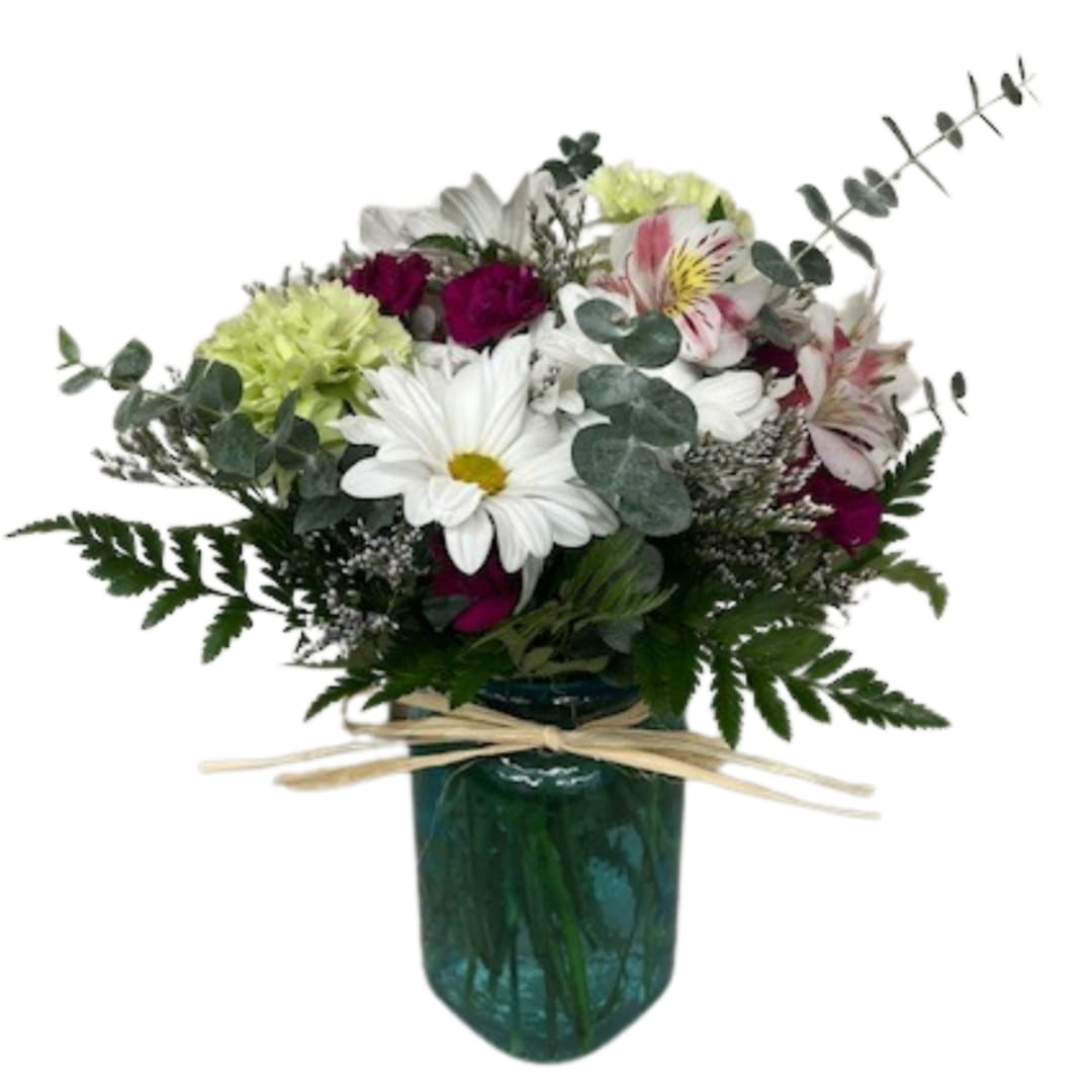 Bouquet of mixed flowers in a green glass vase with a ribbon bow