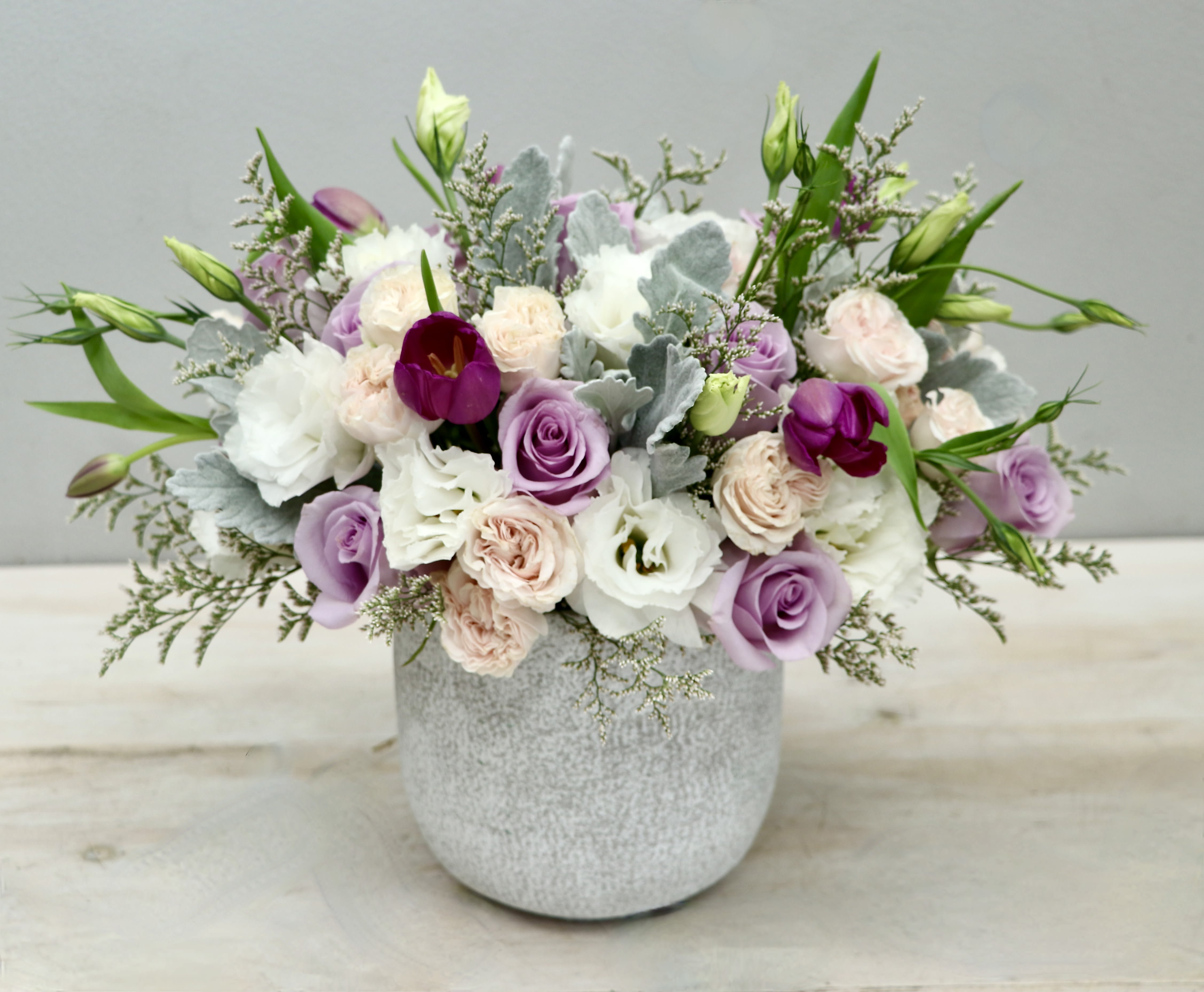 Amethyst Frost - WeHo - This arrangement combines white and blush flowers with purple toned roses and tulips.