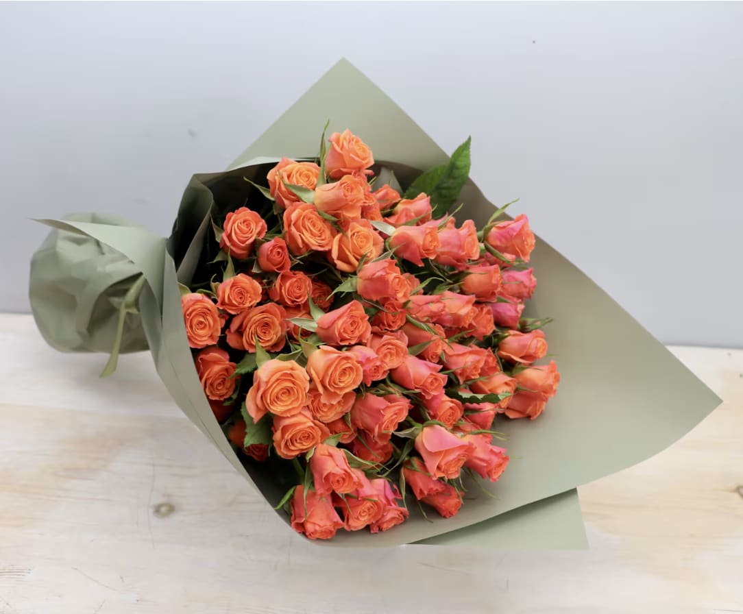 Orange Spray Rose Bouquet - WeHo  - A bouquet made with beautiful spray roses!  Each standard bouquet is made with 20 stems. Each stem has several mini roses and buds attached. Length and size of individual roses may differ between varieties.