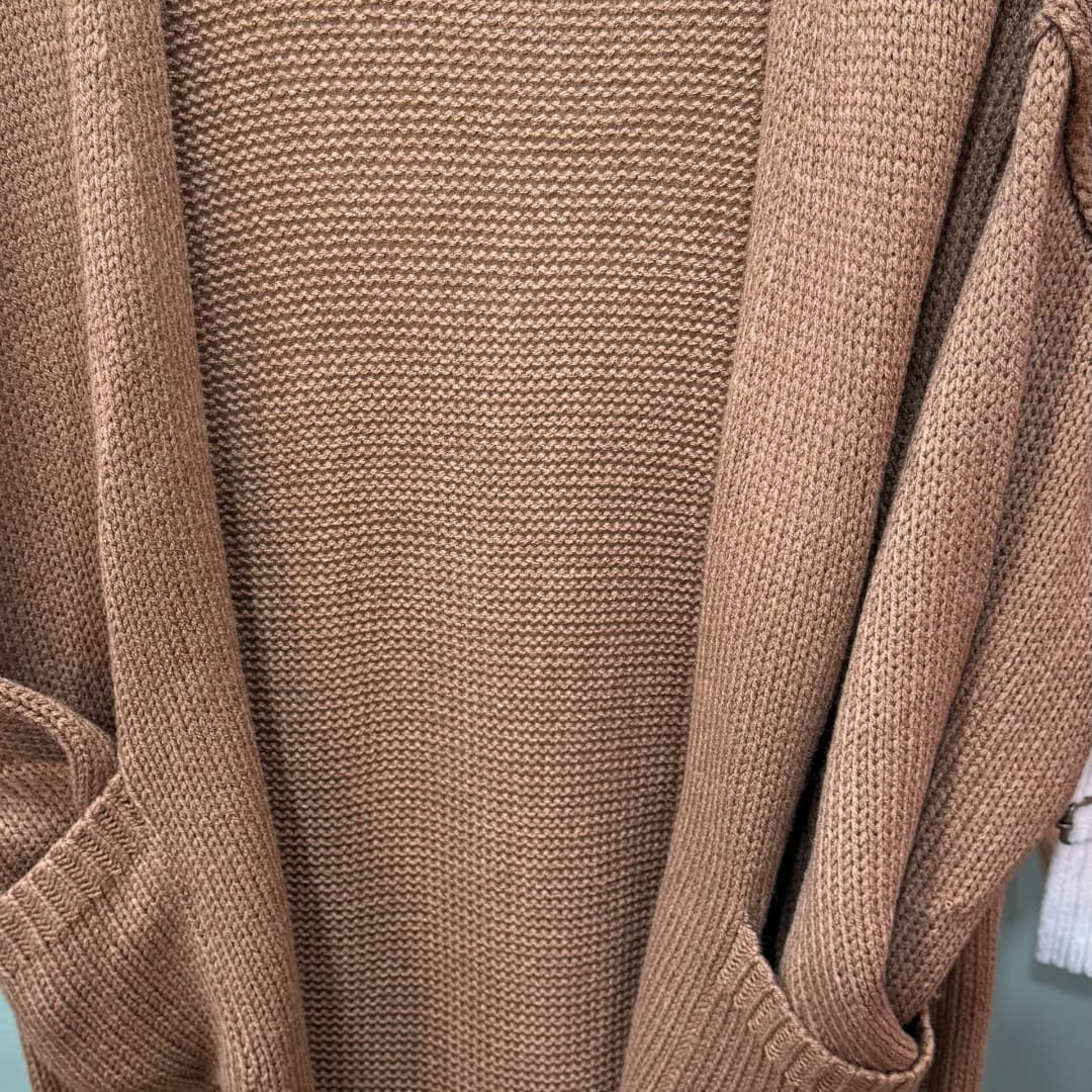 Close-up of a tan knitted cardigan or sweater