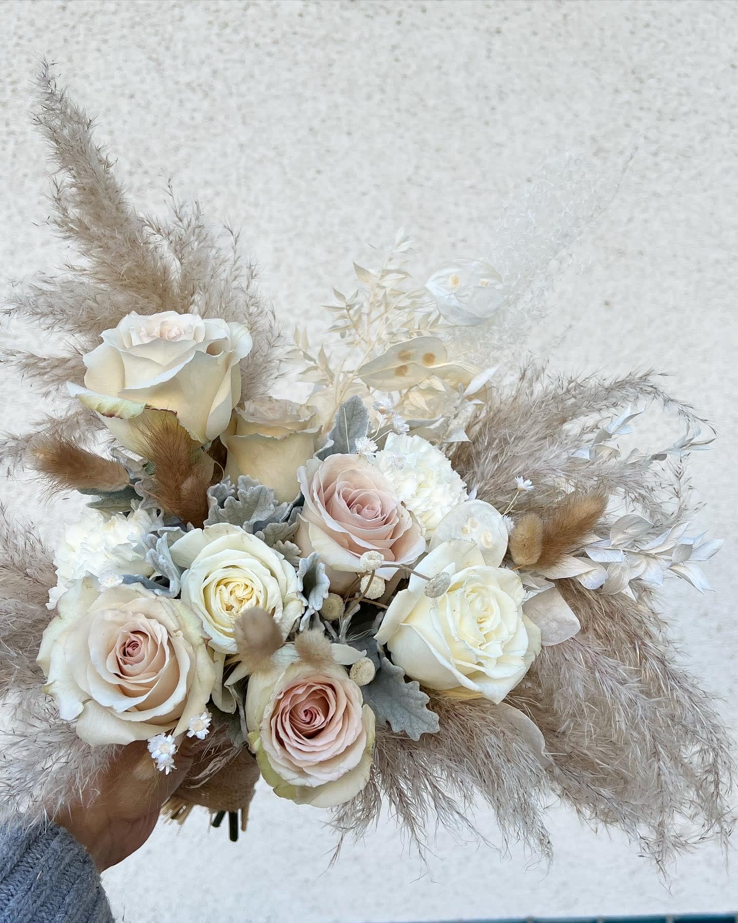 Bouquet of cream and blush roses with dried pampas grass