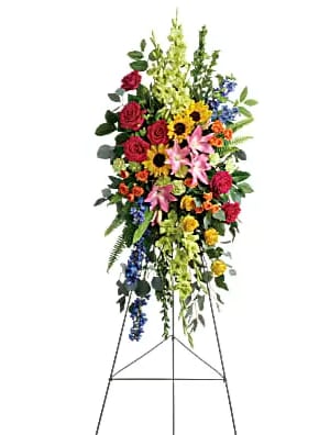 Tall standing floral spray with mixed colorful flowers on an easel