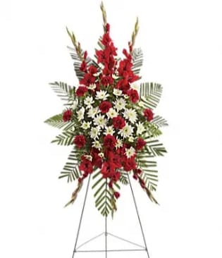 Standing floral spray with red and white flowers on an easel