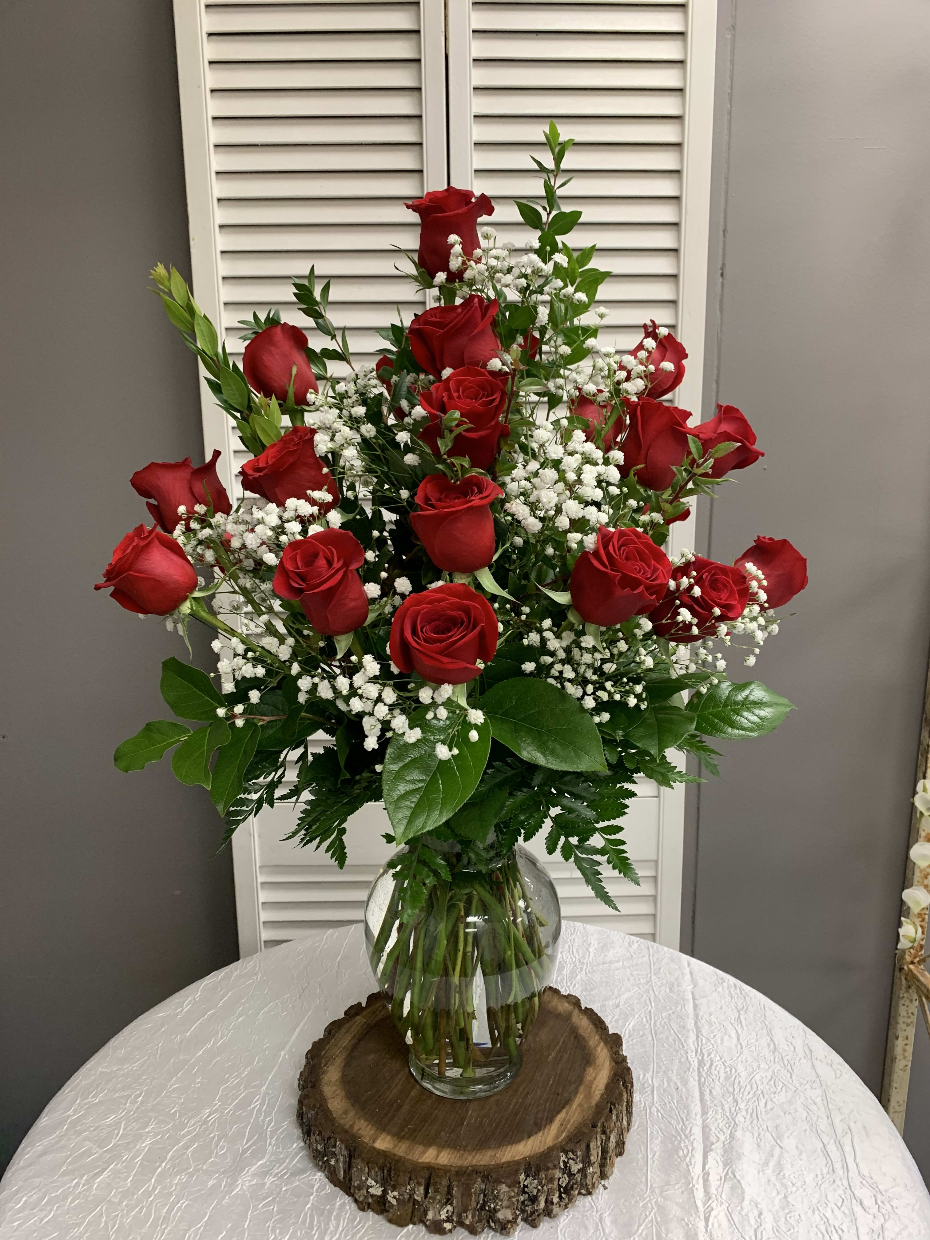 Two Dozen Red Roses Arranged with Filler Flowers - Two Dozen Red Roses Arranged in a Vase with a filler flower to complement the roses. Filler flowers may vary.