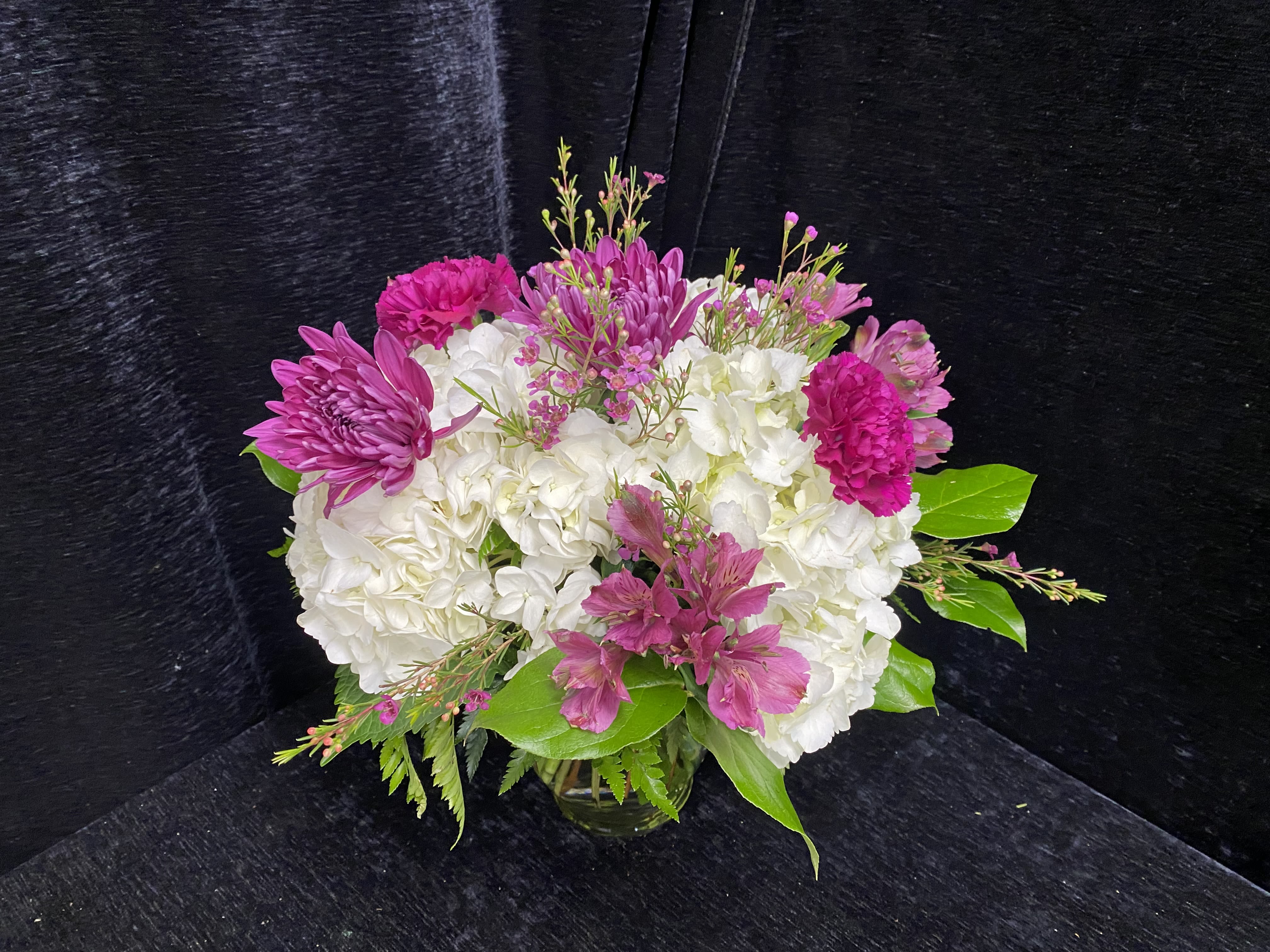 Fun and Fuchsia - Arrangement includes White Hydrangea, Purple Spiders, Fuscia Carnations, Fuscia Alstromeria and Wax Flower