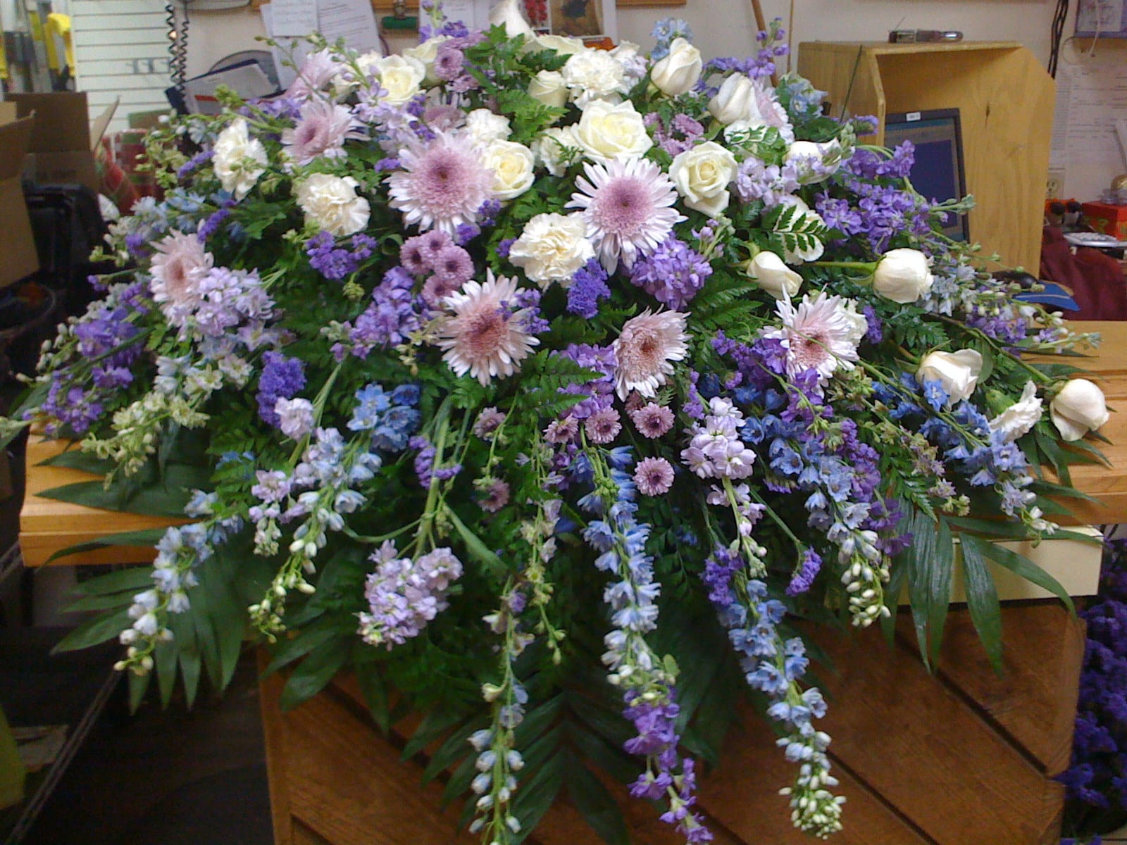 Large casket spray with white and lavender flowers