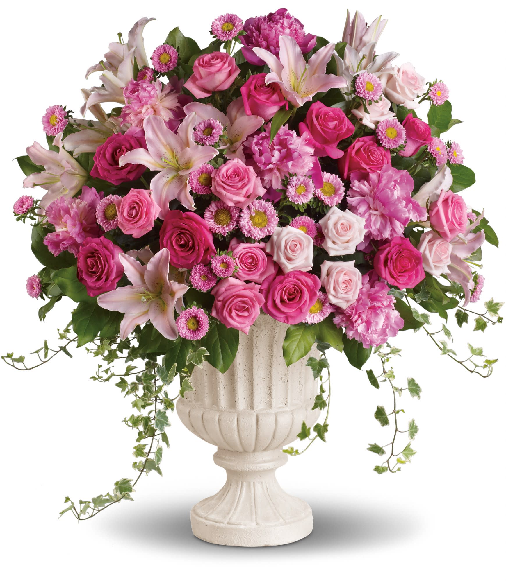 Pink roses and lilies arranged in a white urn vase