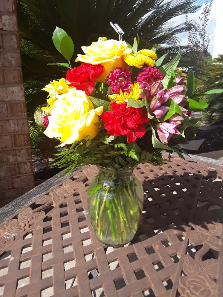 Brighten Your Day - Roses, alstroemeria, asters, carnations and chrysanthemums are delivered in a cheerful clear glass vase. Approximately 12" W x 13" H.   Please note that cancellations are subject to a 10% processing fee, or up to a $25 fee for all refunds processed.