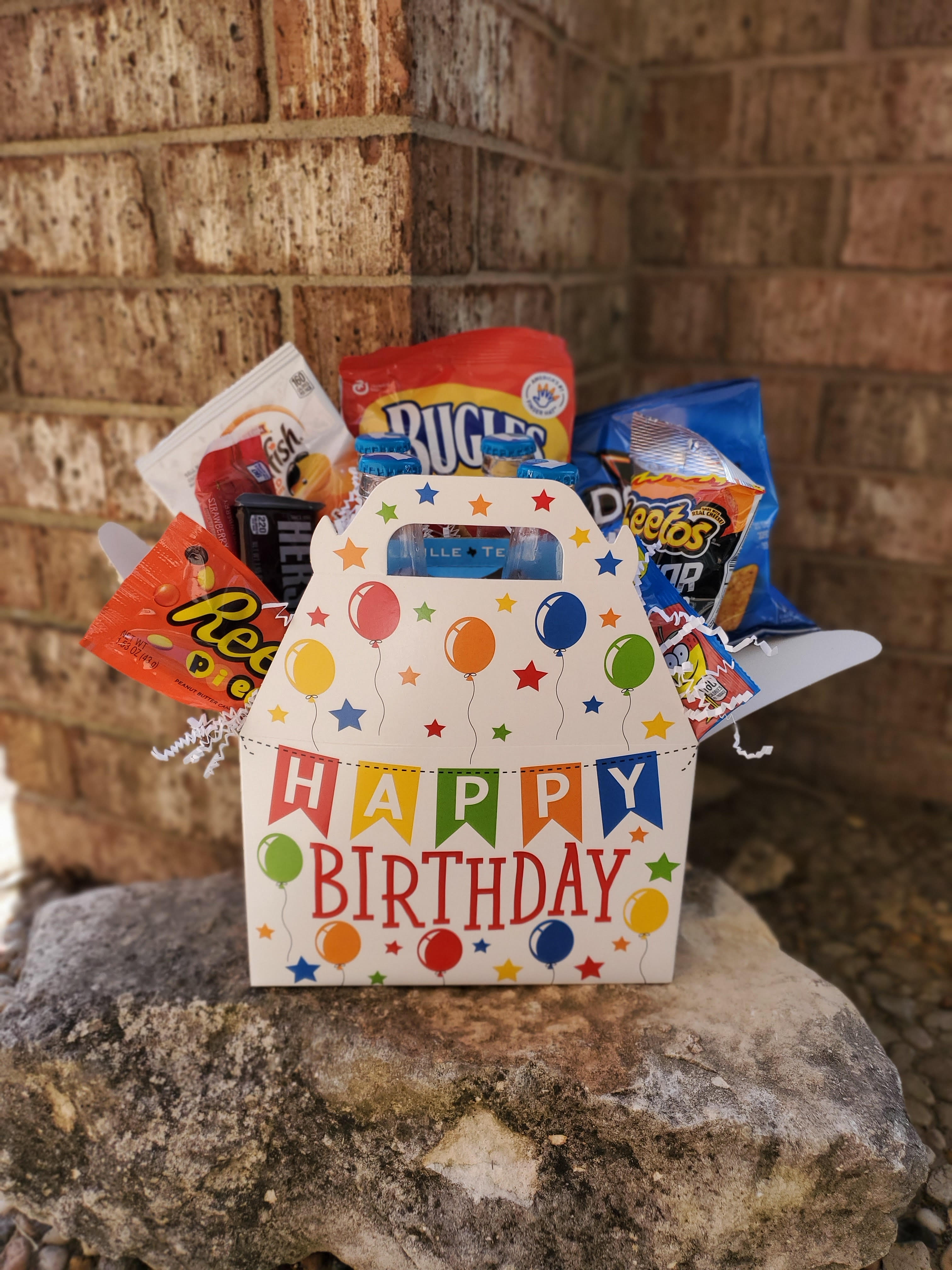 Birthday gift basket with assorted snacks in a decorated box