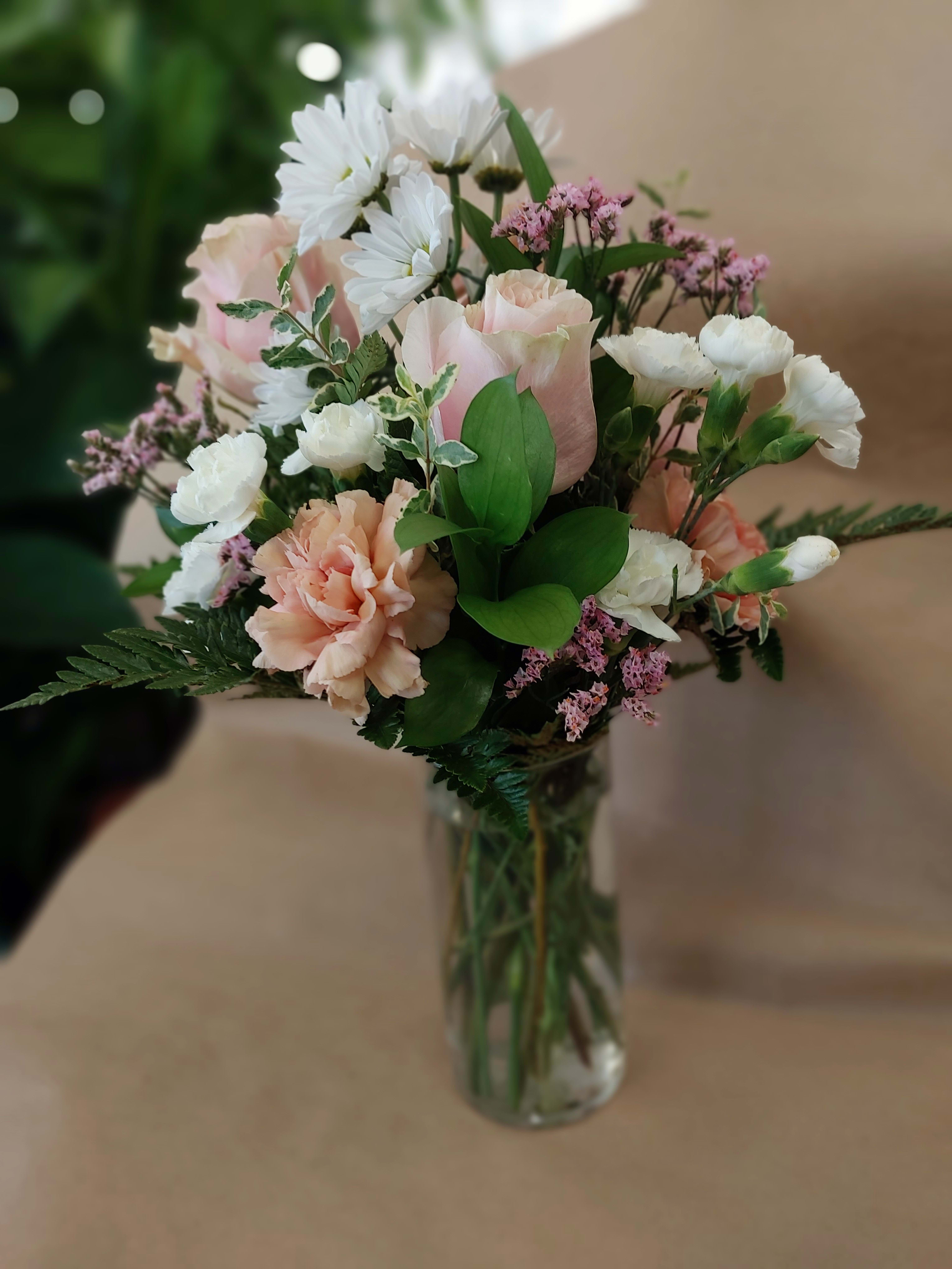 Pink and white bouquet in a clear glass vase