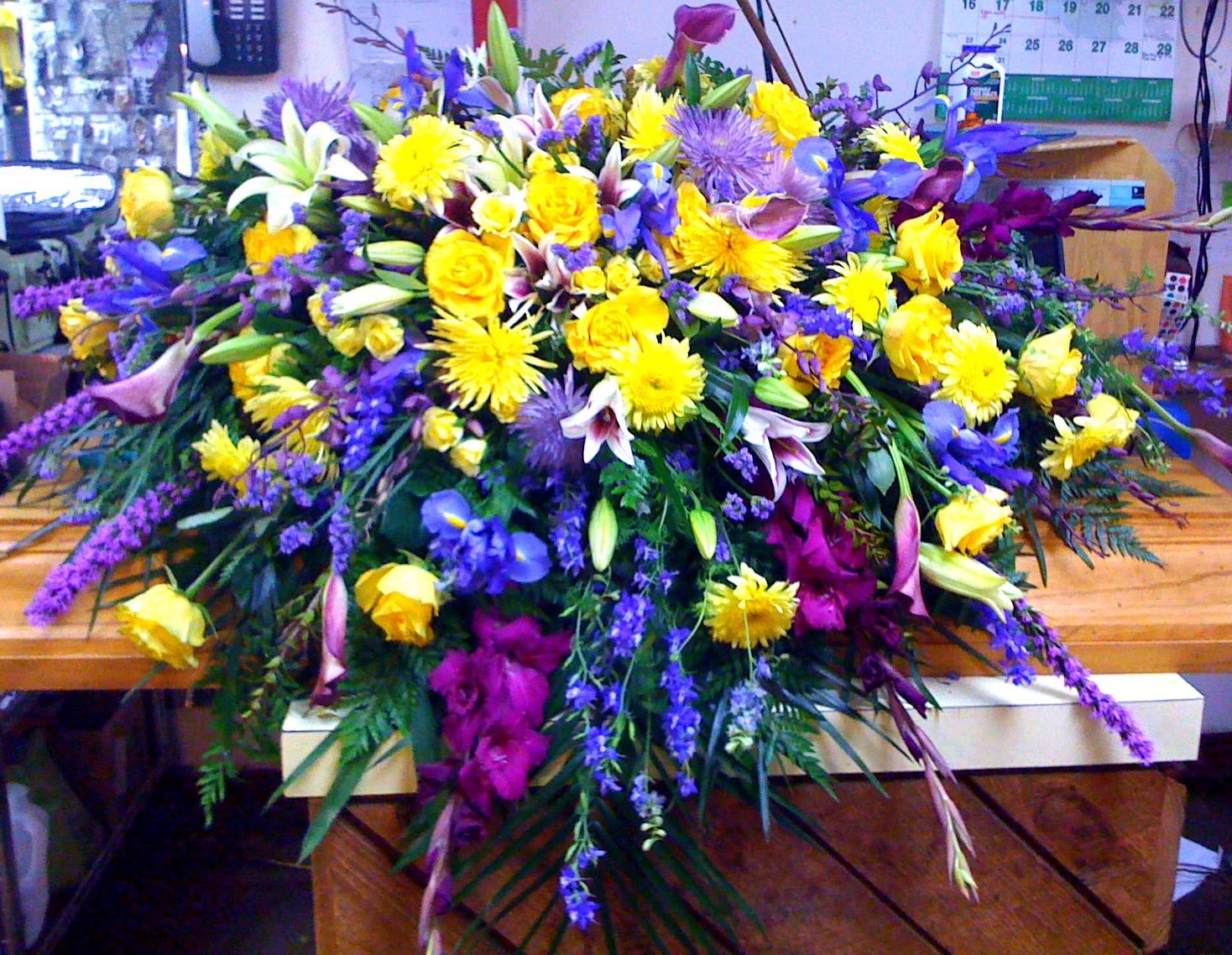 Large mixed floral spray with yellow, purple, and white blooms