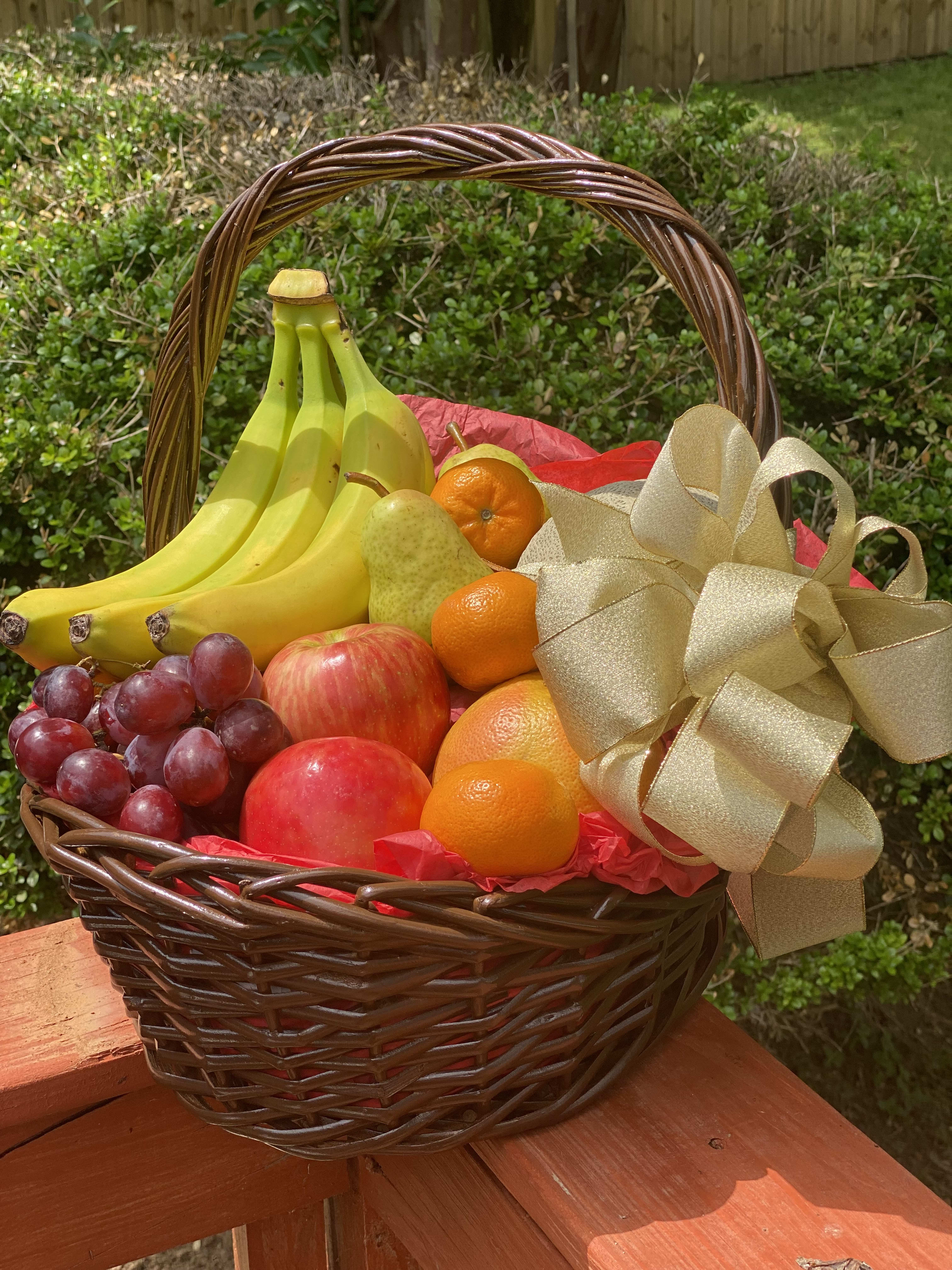 Fruit basket with bananas, grapes, apples, pears, and oranges