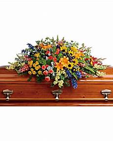 Colorful floral spray on a wooden casket