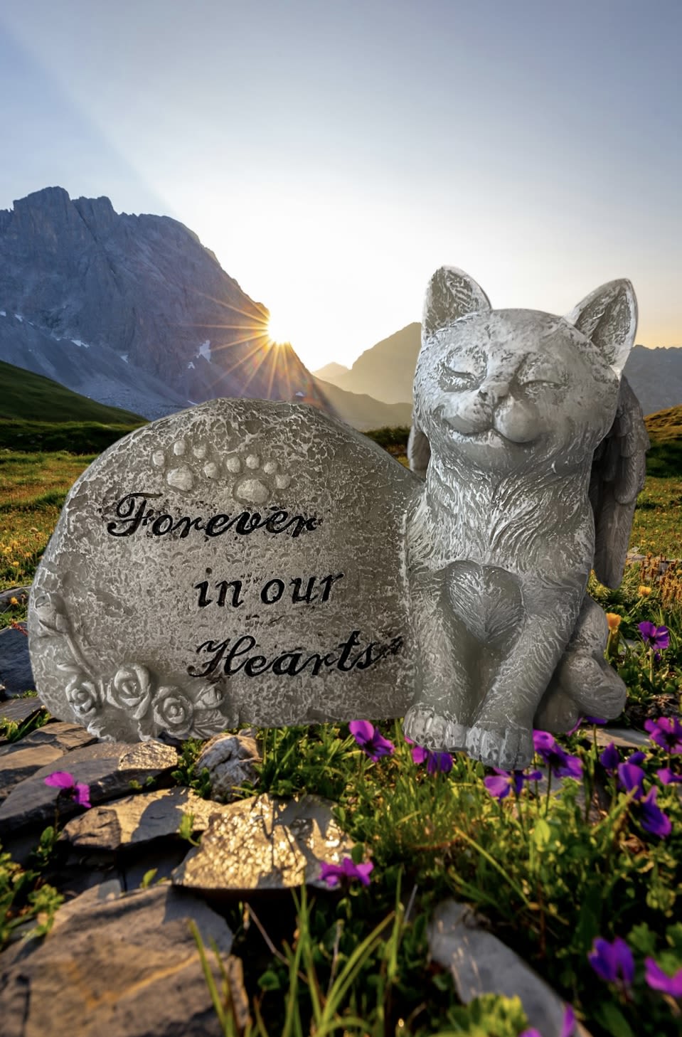 Cat memorial statue beside a stone reading "Forever in our Hearts"