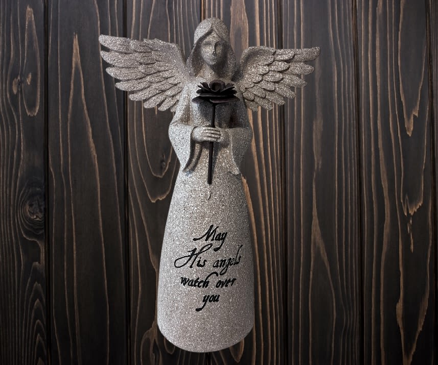 Glittery angel figurine holding a rose with a memorial message