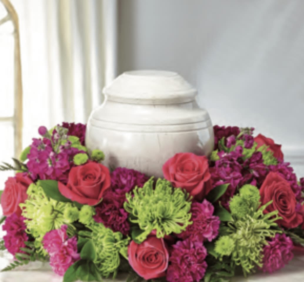 Bright Horizon - This urn arrangement has fuchsia,  stock, hot pink roses, green chrysanthemums, green buttons, hot pink carnations, and beautiful greenery. Please note the urn is not included. 