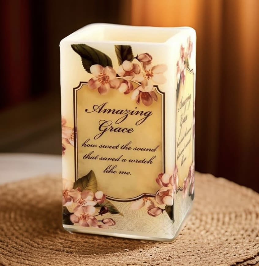 Decorative candle with floral print and the words Amazing Grace