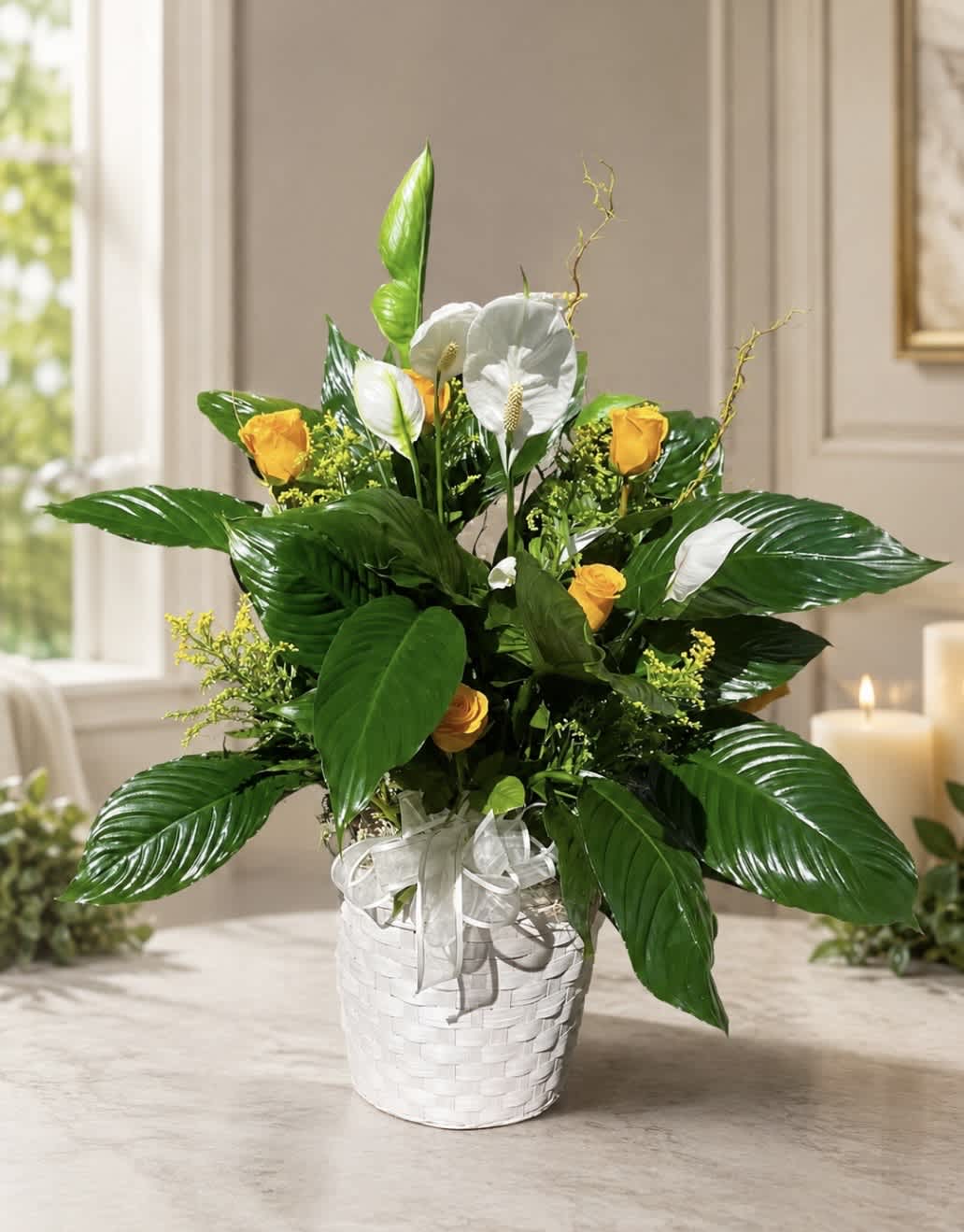 White and yellow floral arrangement in a white basket
