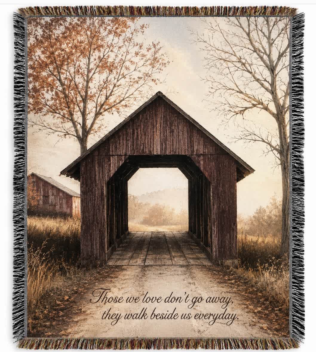 Fringed throw blanket with a covered bridge scene and memorial quote