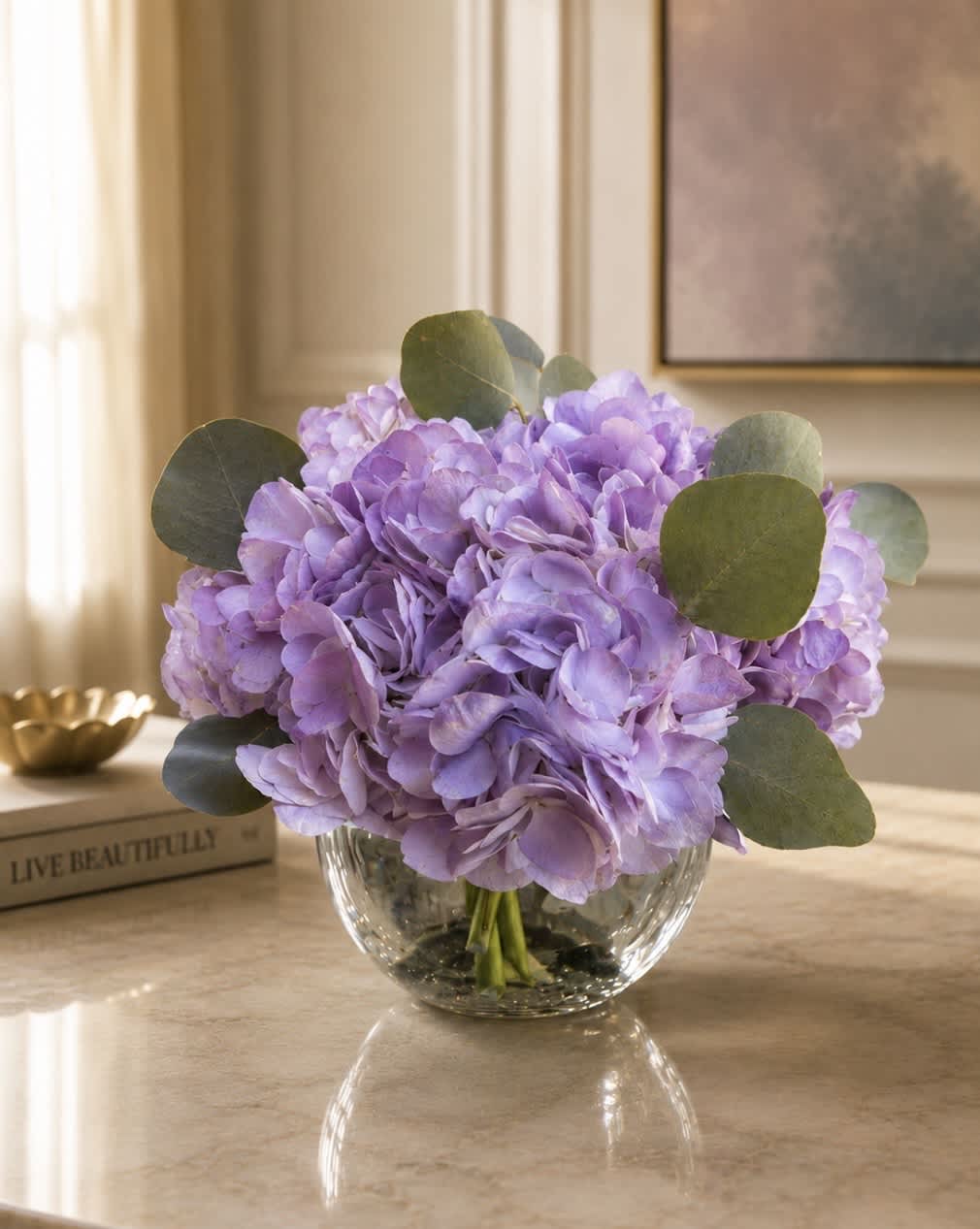 Lavender hydrangea bouquet in a clear glass vase