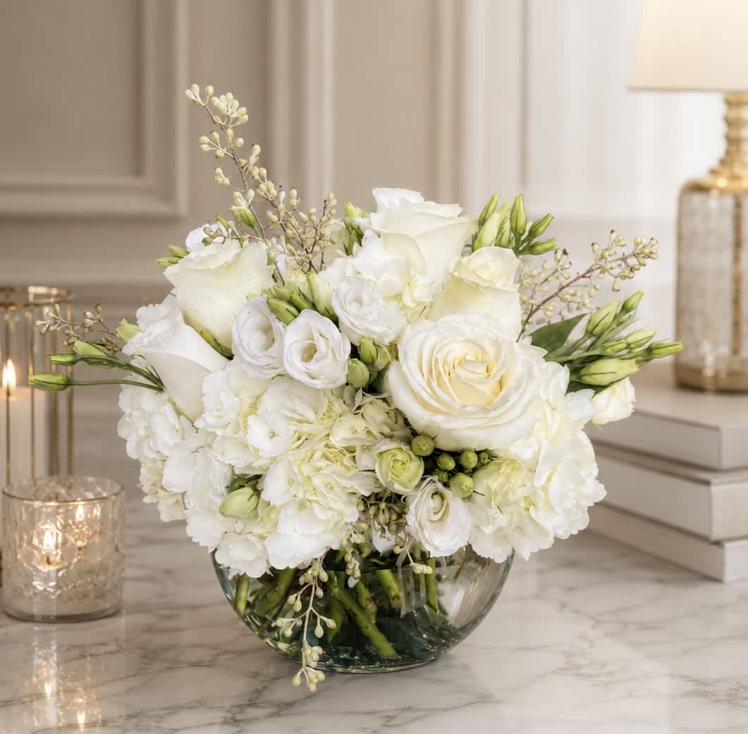White floral arrangement in a clear glass bowl vase