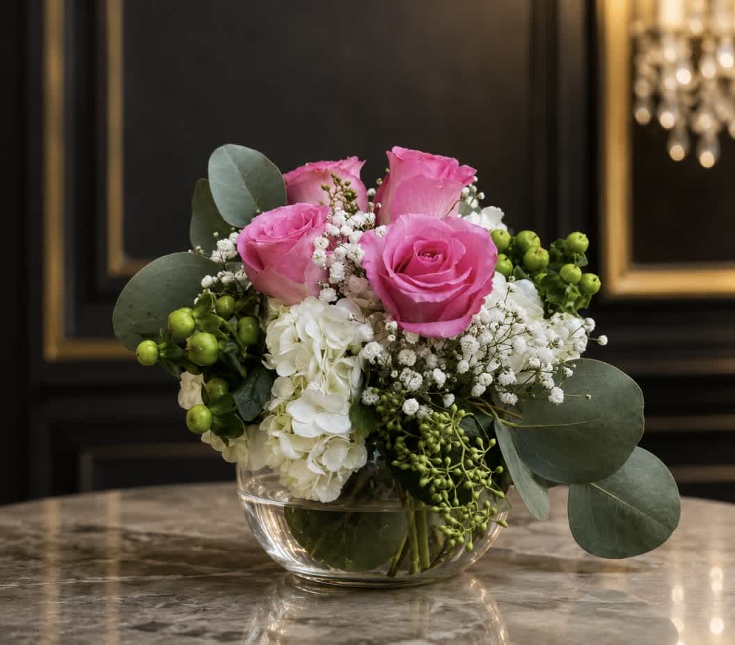 Pink roses and white hydrangeas in a clear glass bowl vase