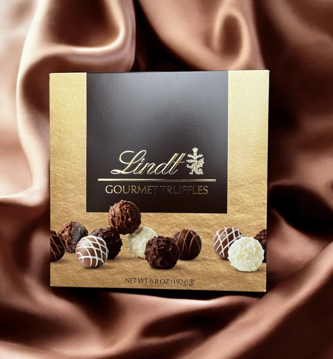 Box of Lindt gourmet truffles on a satin background