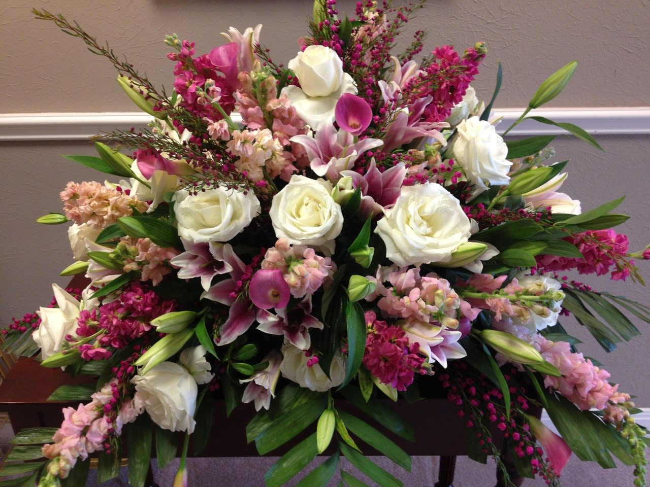 Beautiful Spray.  -    We are sorry for your loss and realize this is a difficult time to think about the flowers you may need, Mercedes will guide you through  this difficult time 24/7.  After hours or get our voicemail please leave a message.  512-291-3536