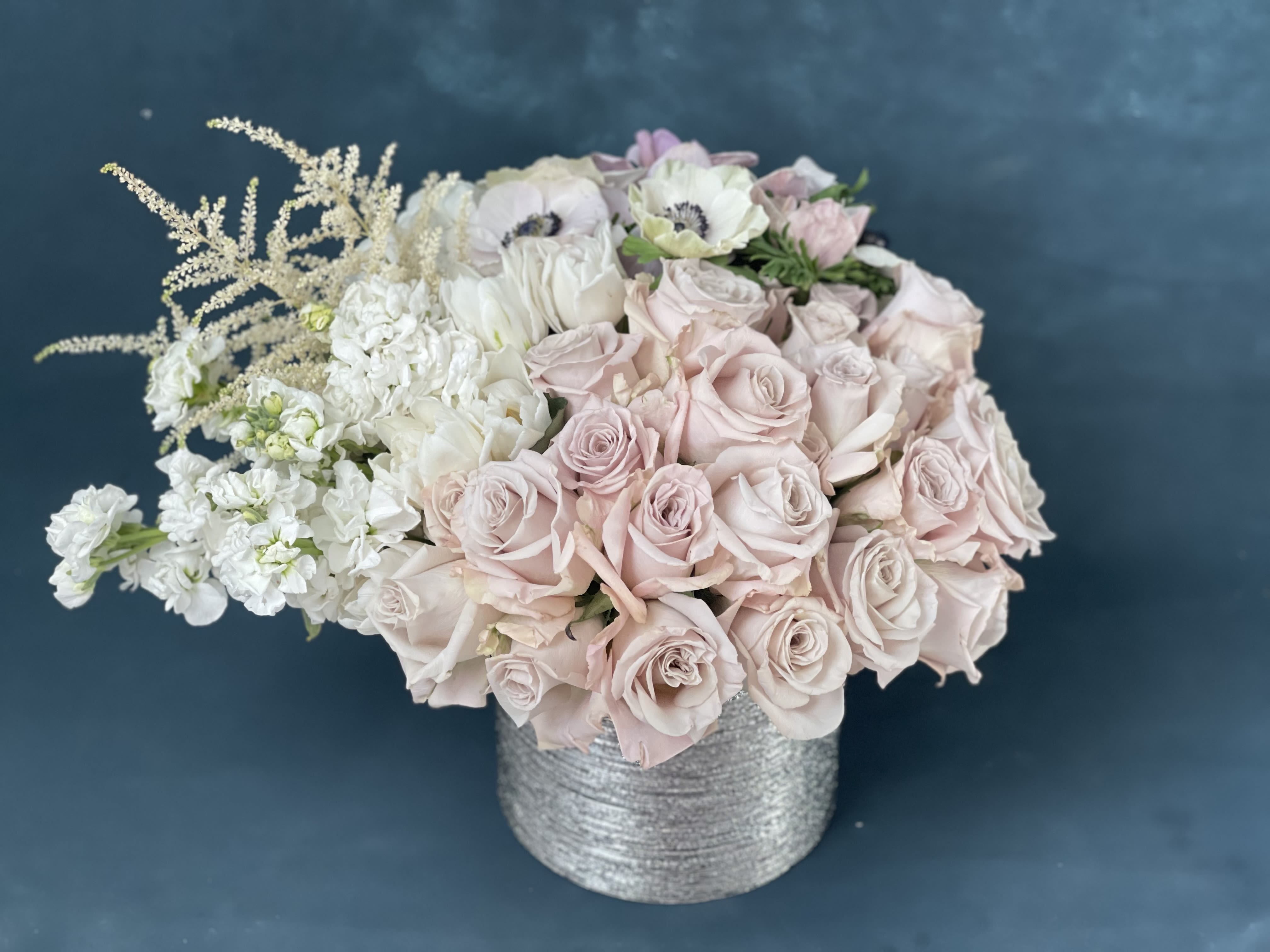 Blush and white rose bouquet in a silver textured vase
