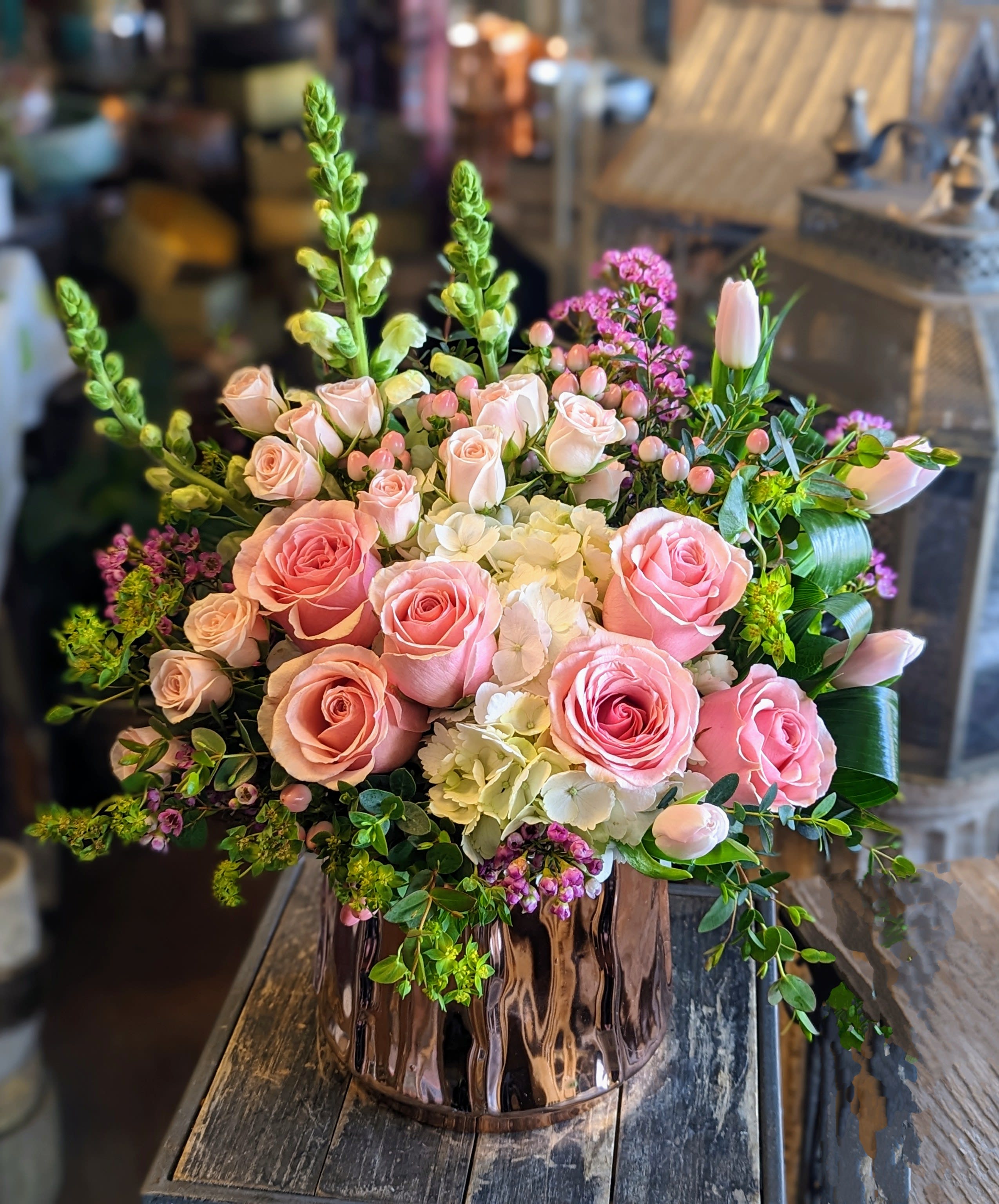 Pink roses and white hydrangeas in a copper vase