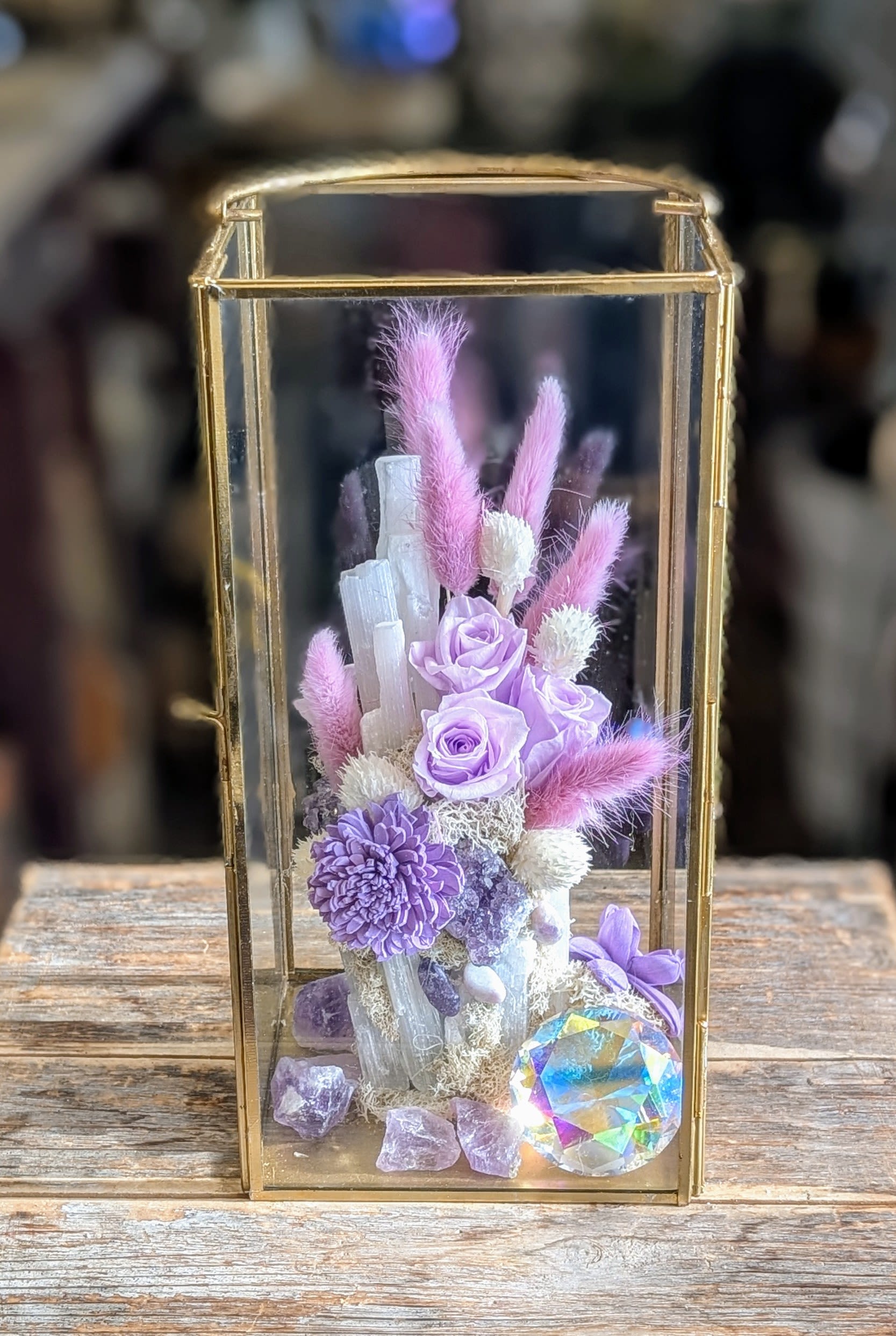 Lavender roses and purple flowers in a gold glass lantern