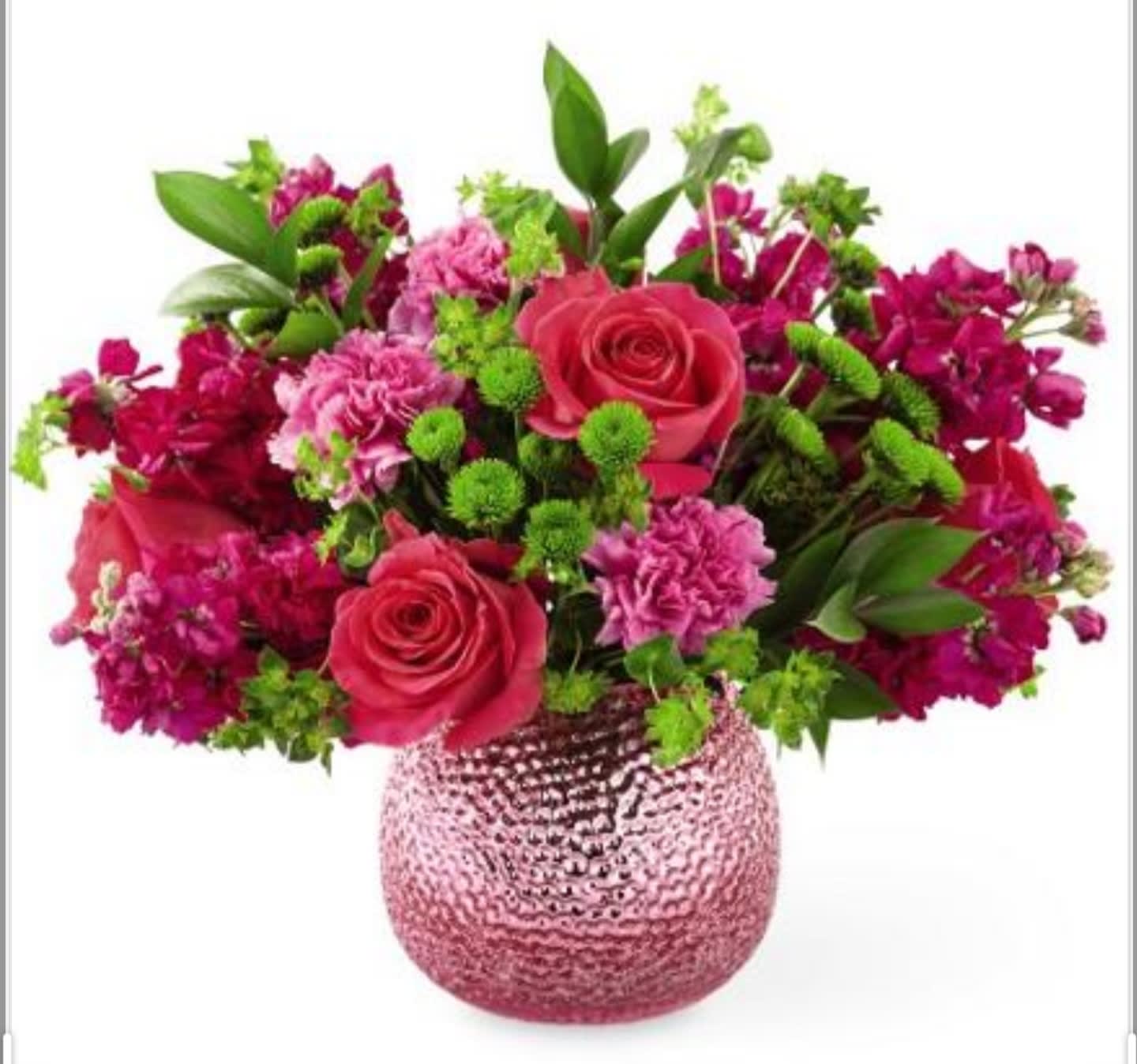 Pink and magenta flower arrangement in a textured glass vase