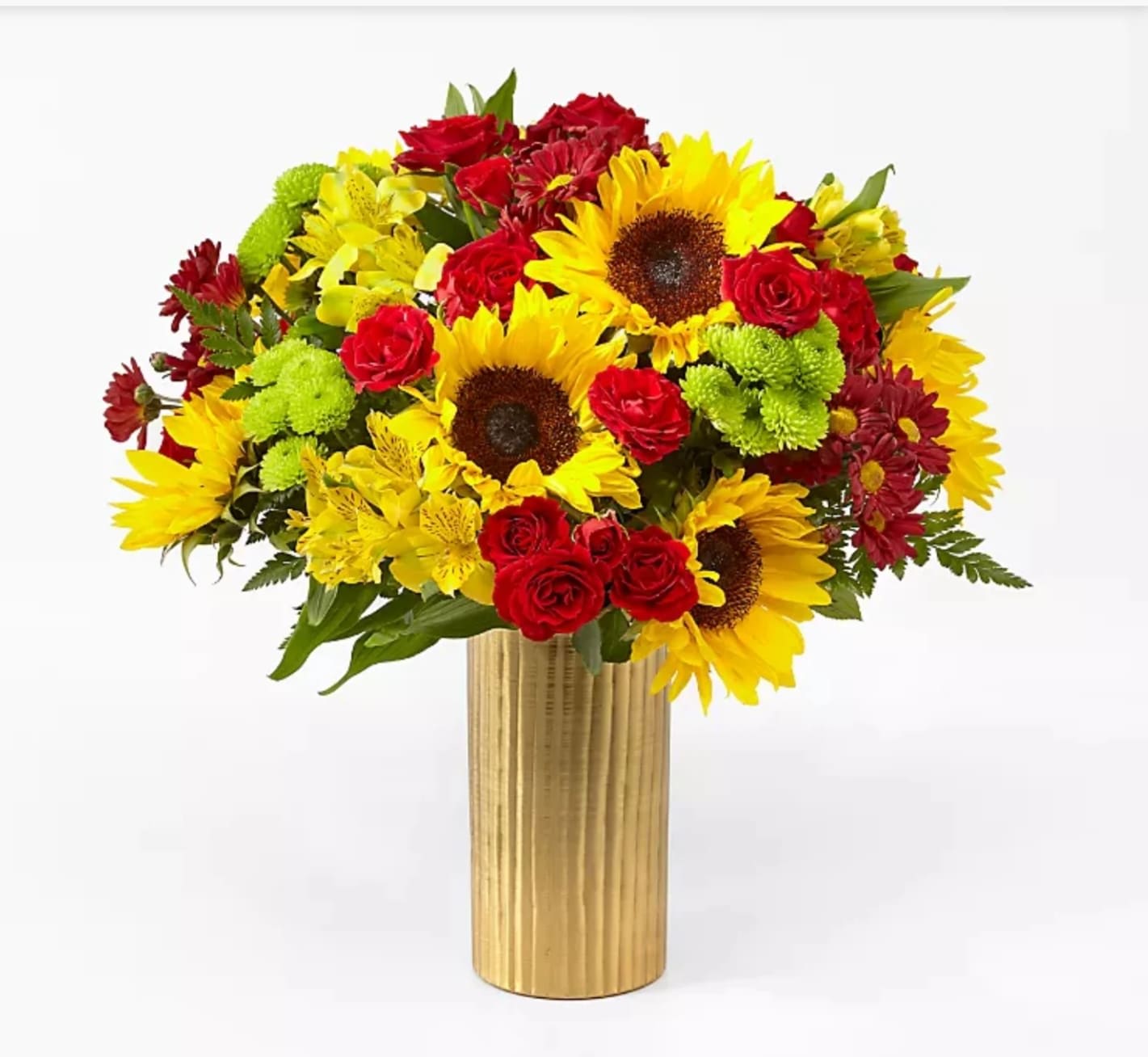 Bouquet of sunflowers, red roses, and yellow flowers in a gold vase