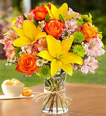 Fields of Europe - Product ID: 90977  Inspired by the spectrum of color in the rolling fields found throughout Europe, our florists designed this gathering of fresh roses, lilies, alstroemeria, poms and more inside a stylish clear glass vase tied with raffia, as a nod to rustic European style. Gorgeous gathering of roses, lilies, alstroemeria, poms, waxflower, monte casino and salal Artistically designed by our select florists in a clear glass gathering vase tied with raffia; vase measures 8"H Large arrangement measures approximately 20"H x 16"L Medium arrangement measures approximately 18"H x 15"L Small arrangement measures approximately 16"H x 14"L Our florists hand-design each arrangement, so colors, varieties, and container may vary due to local availability Lilies may arrive in bud form and will open to full beauty over the next 2-3 days