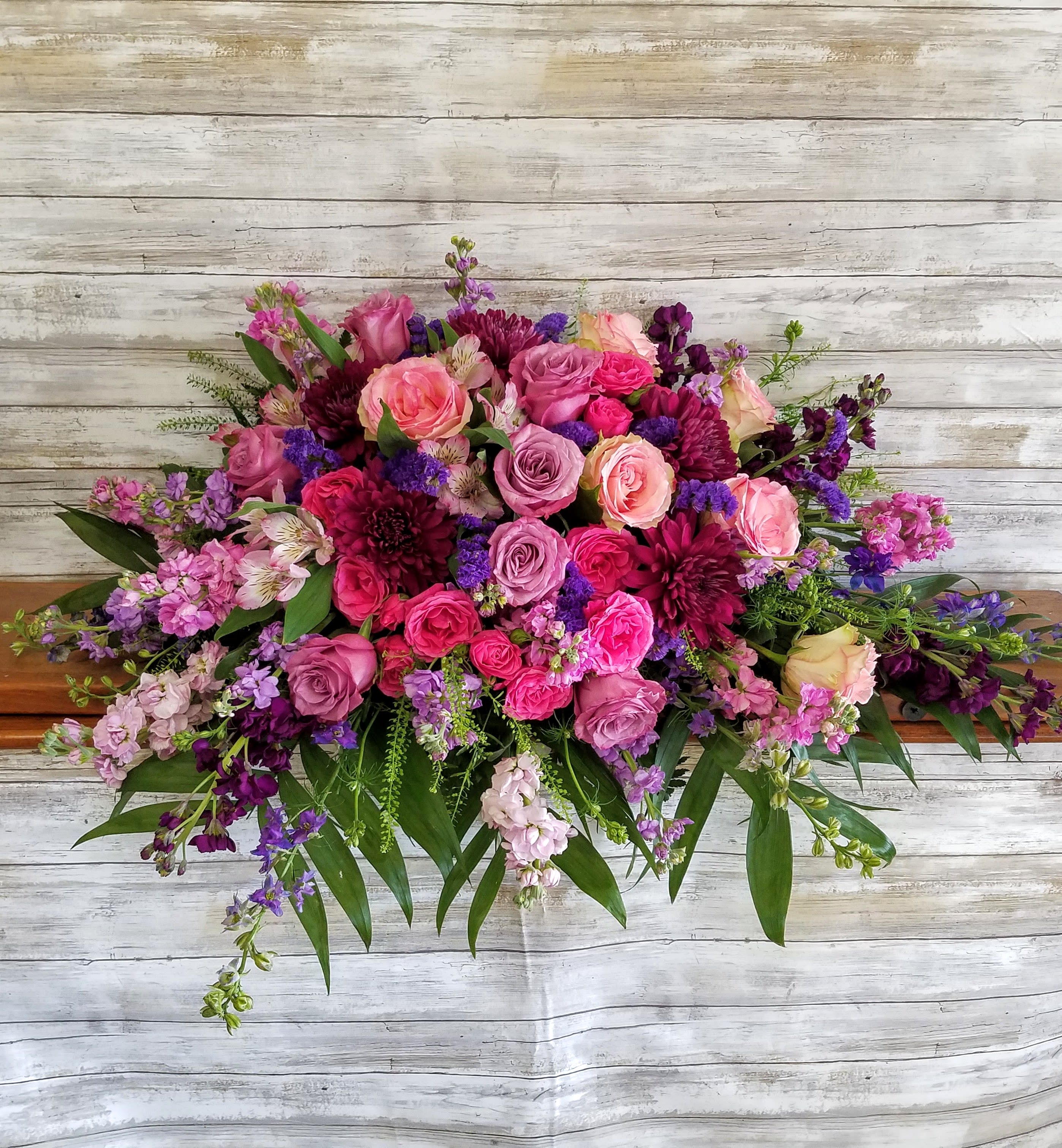 Large bouquet of pink and purple roses with mixed blooms