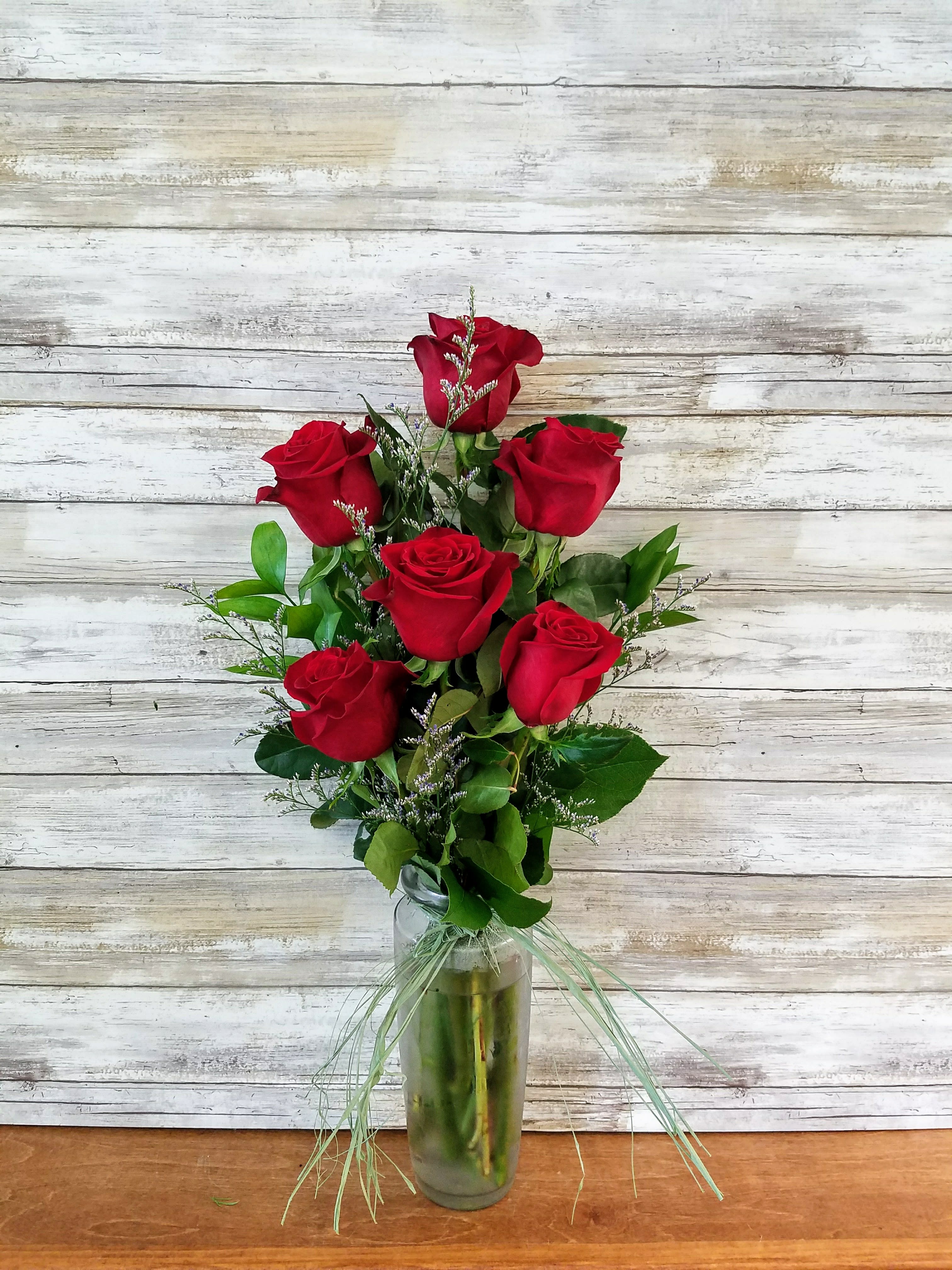 Bouquet of red roses in a glass vase