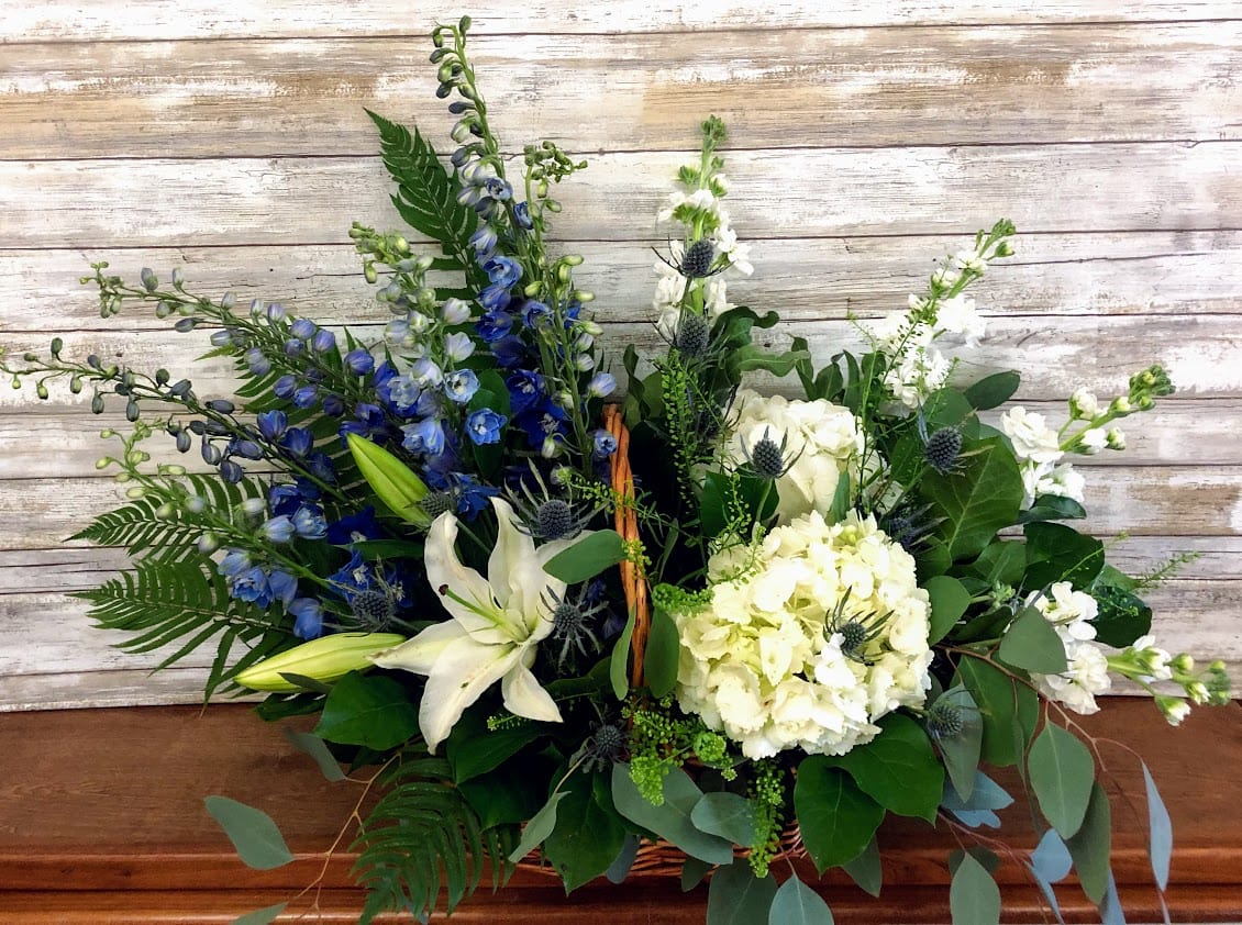 Blue and white floral arrangement in a basket
