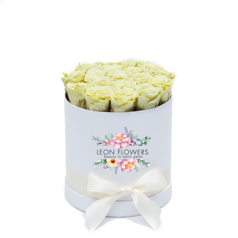 Box of pale yellow roses with a white ribbon