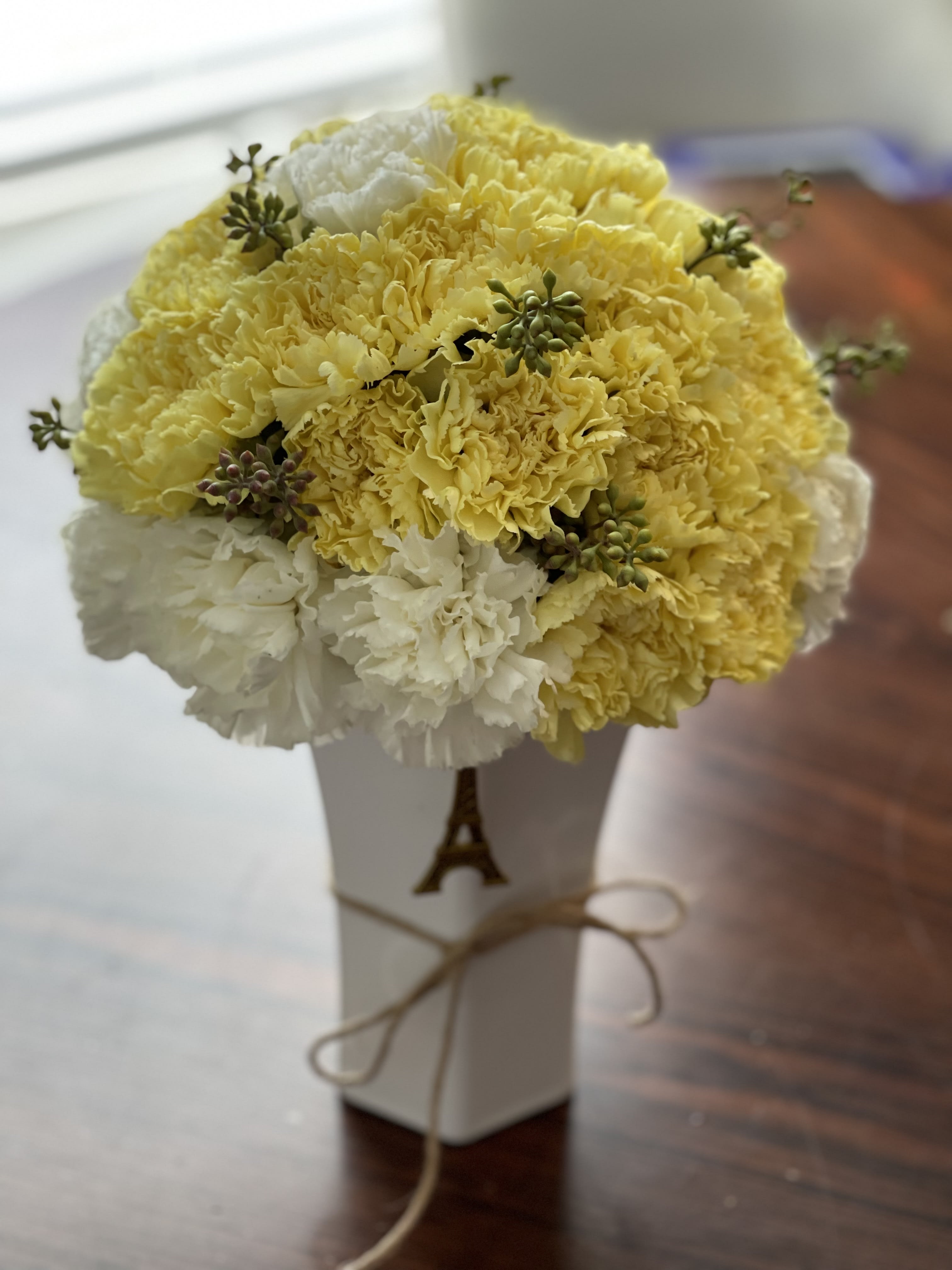 Yellow and white carnation bouquet in a white box with ribbon