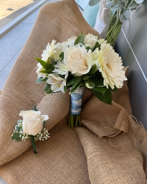 White rose and daisy bouquet with a matching boutonniere