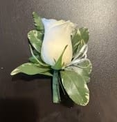 White rose boutonniere with green leaves