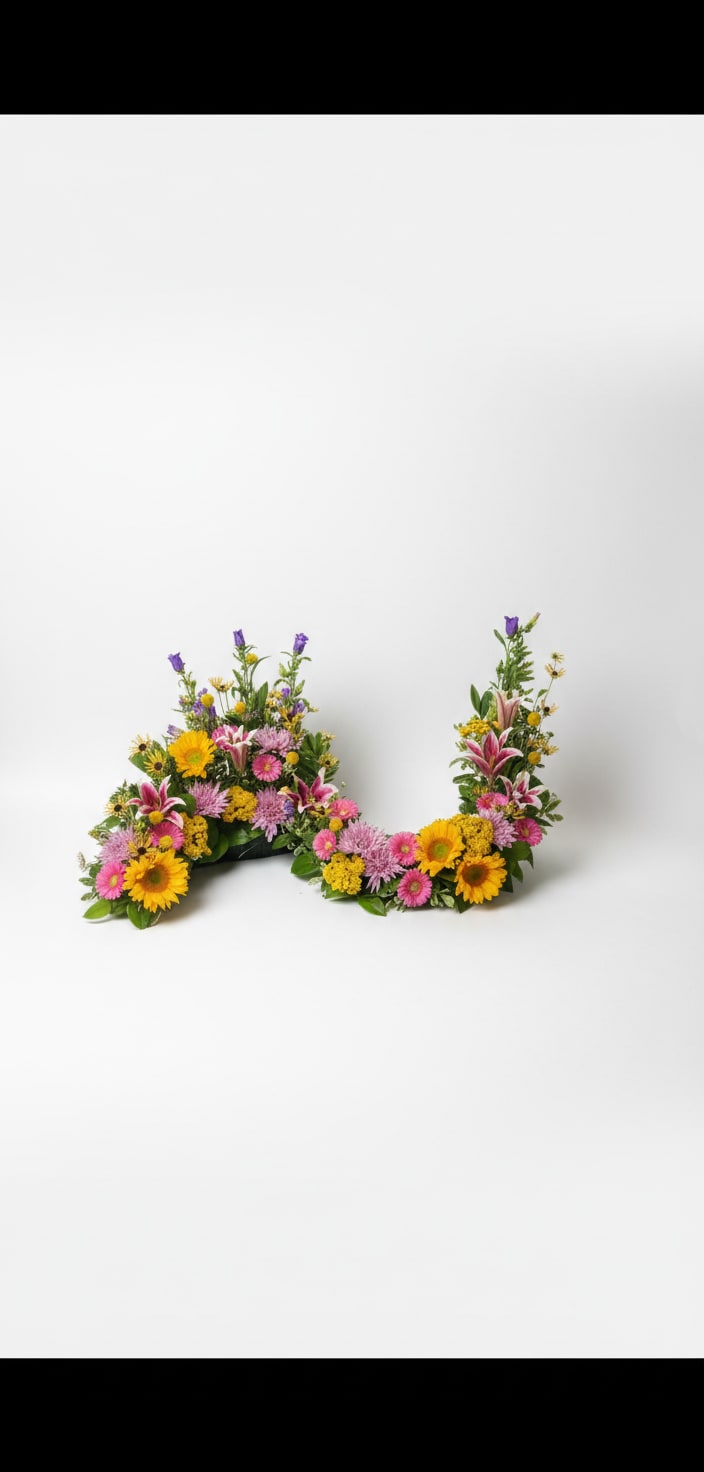 Two colorful floral arrangements shaped like the letter U on a white background