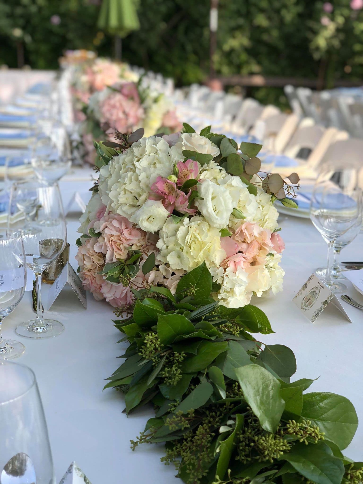 Pastel floral centerpiece on a long banquet table