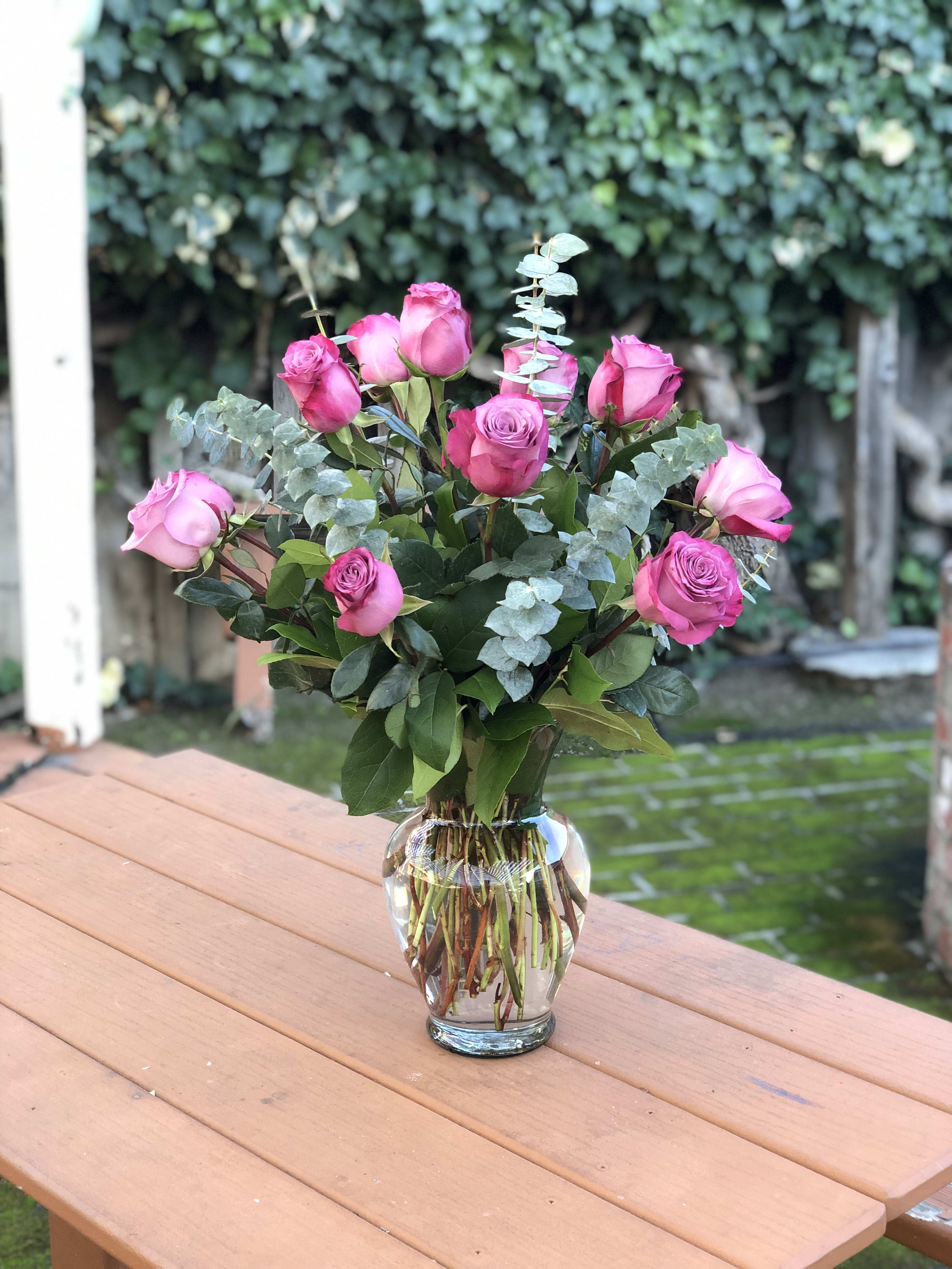 Pink roses arranged in a clear glass vase