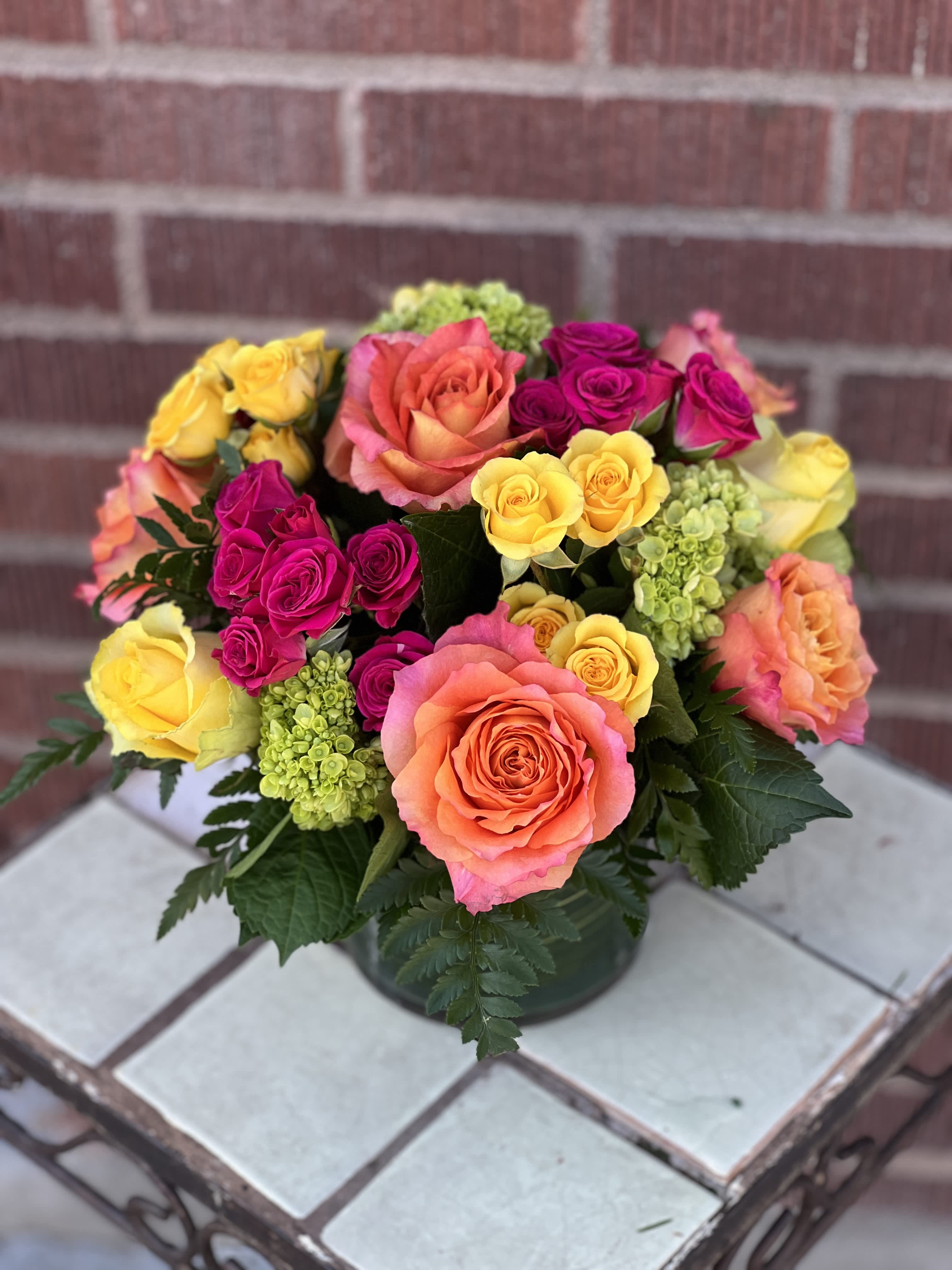 Colorful bouquet of roses in a low vase