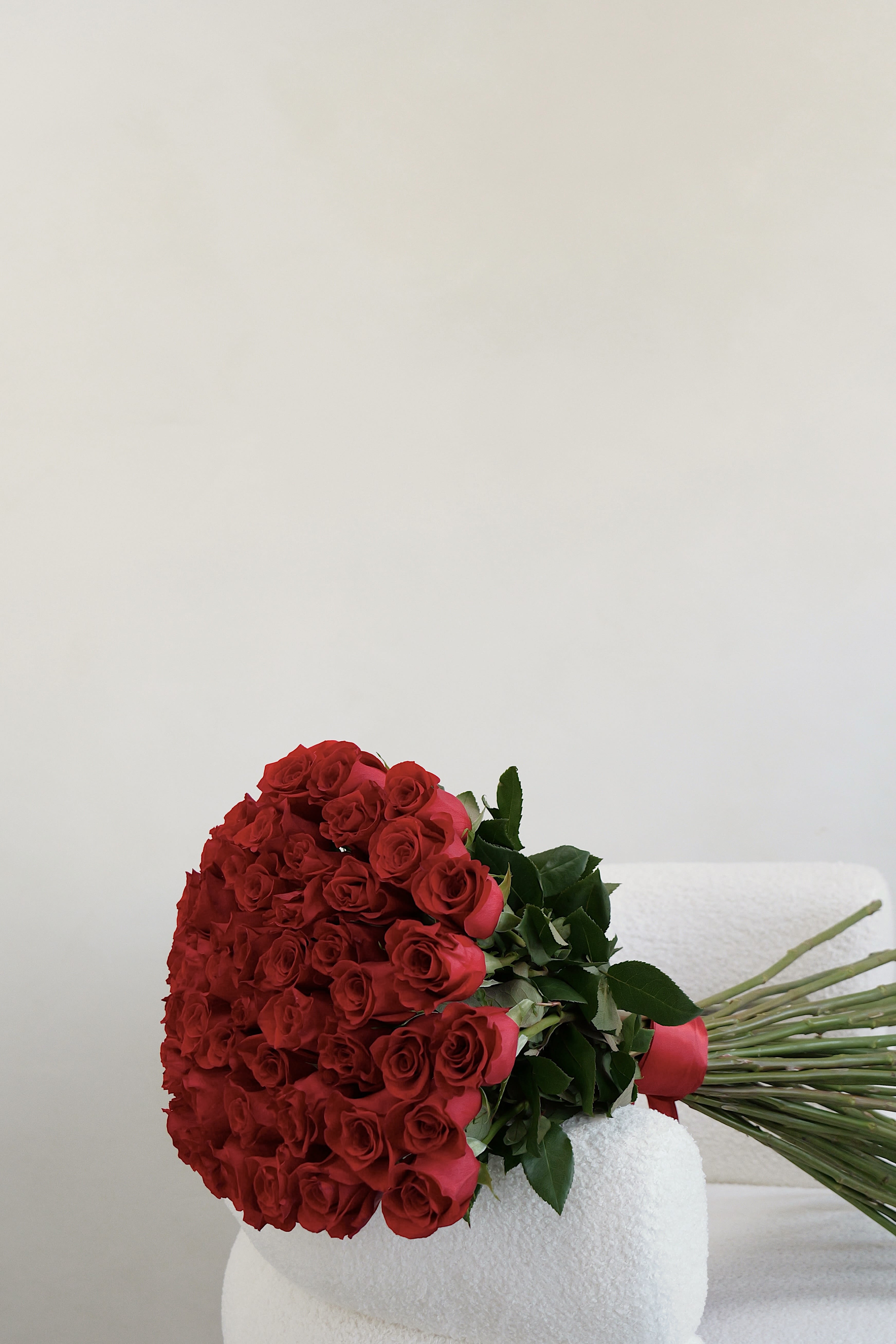Large bouquet of red roses with green leaves